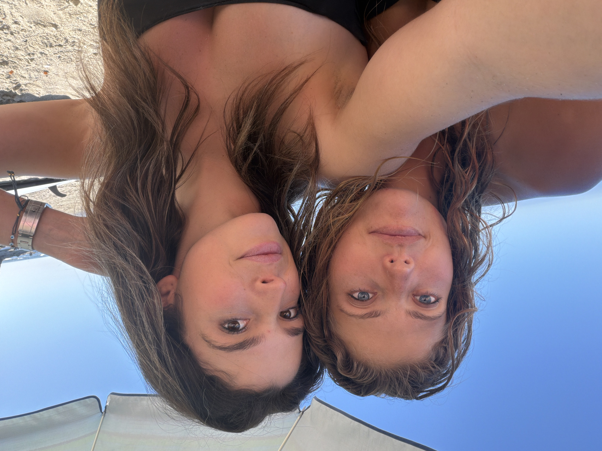 Women take beach selfie during evening in Malibu