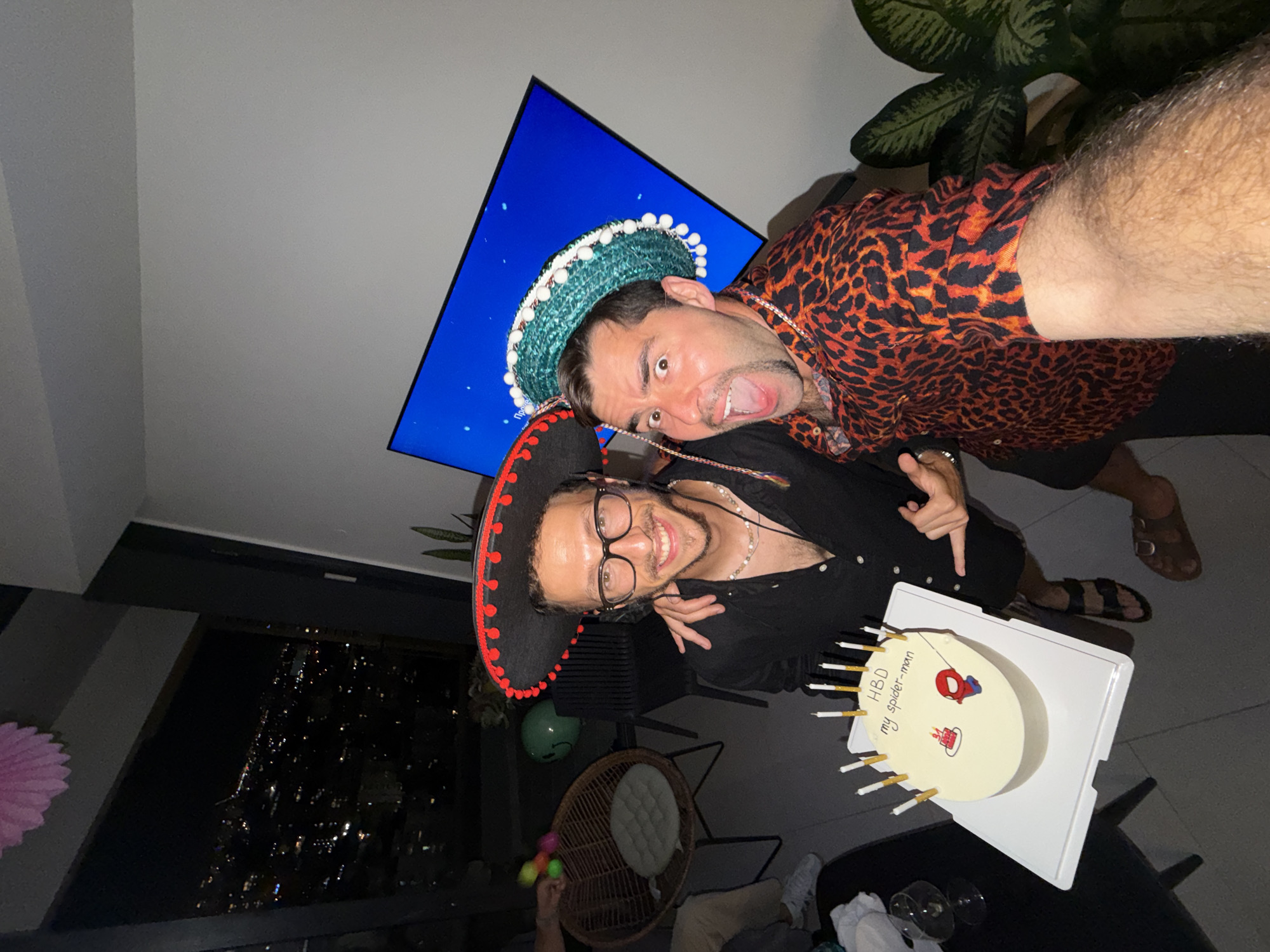 Sombrero selfie on a Tel Aviv balcony at night