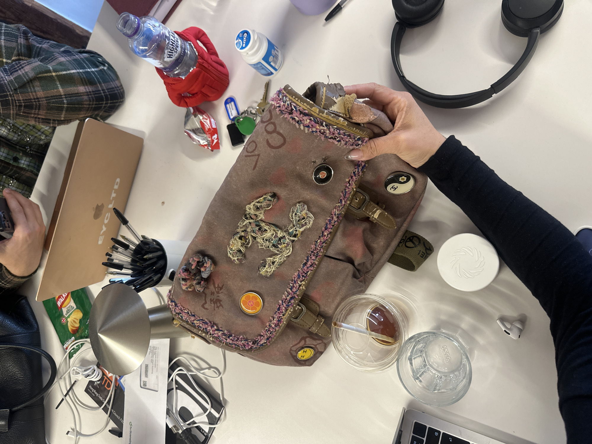 Two people work at cluttered desk in London office