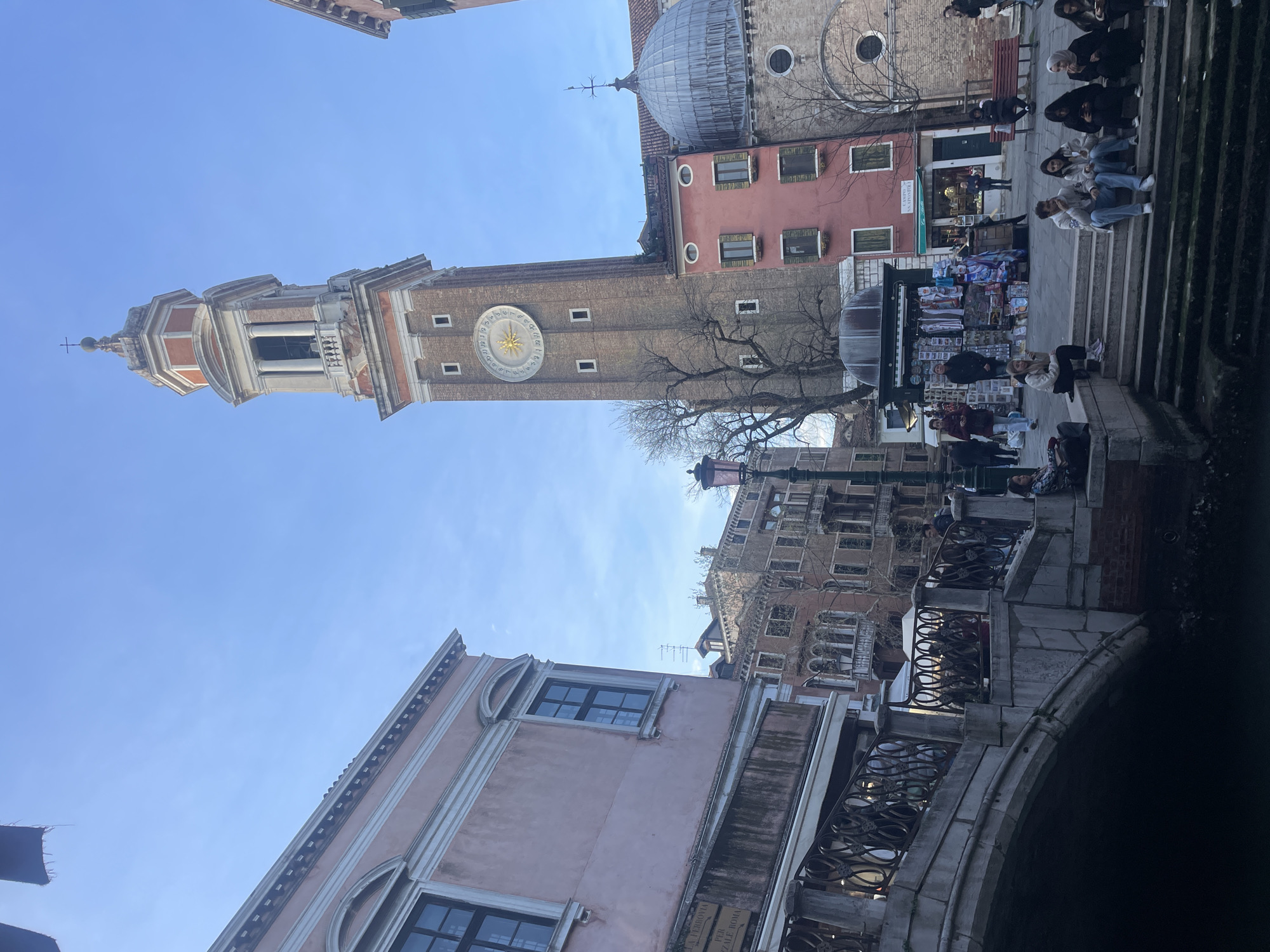 Venice tourists observe iconic campanile and gondola scenes