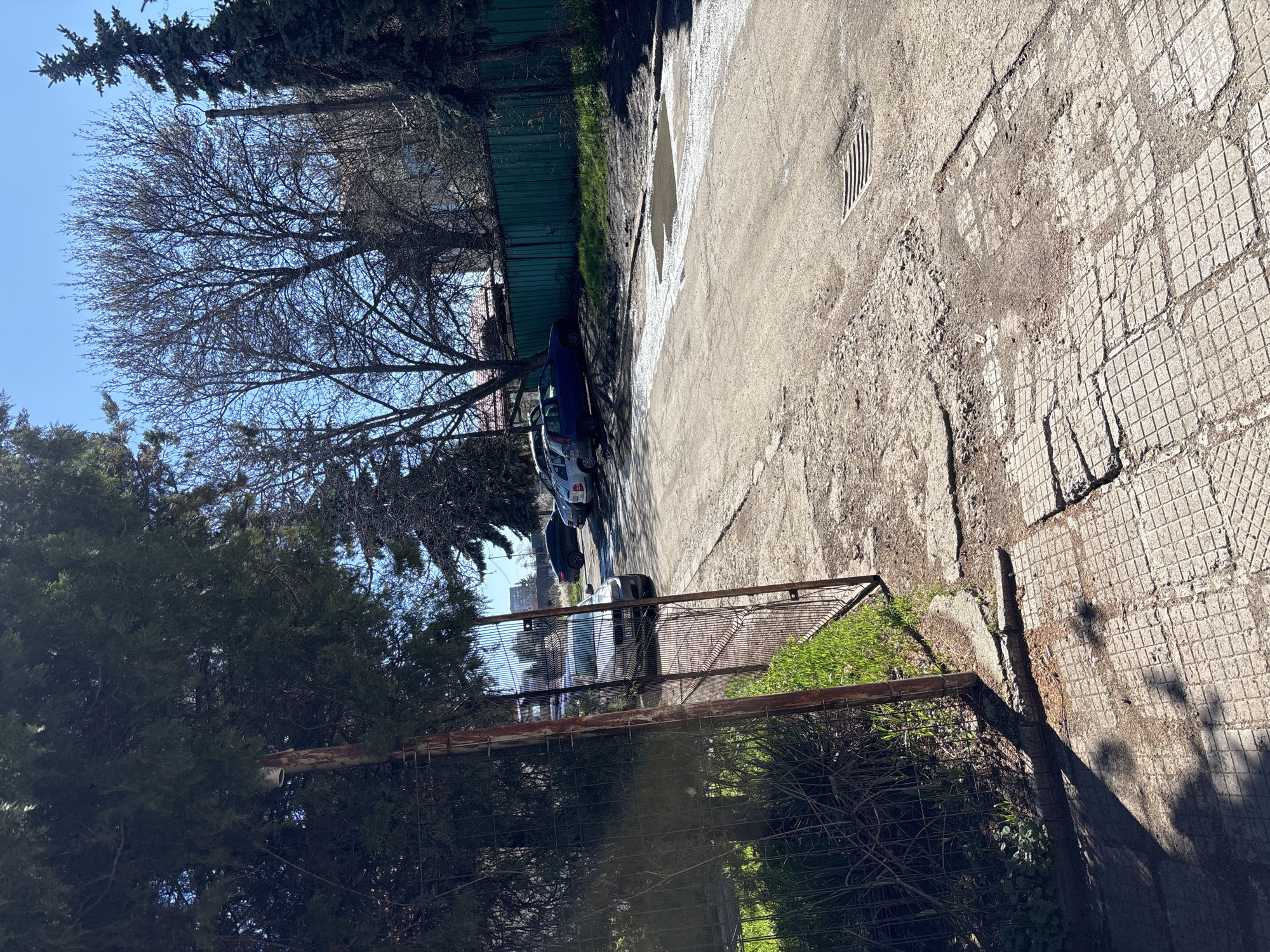 Morning street scene captured in Sofia alleyway with reflective puddle