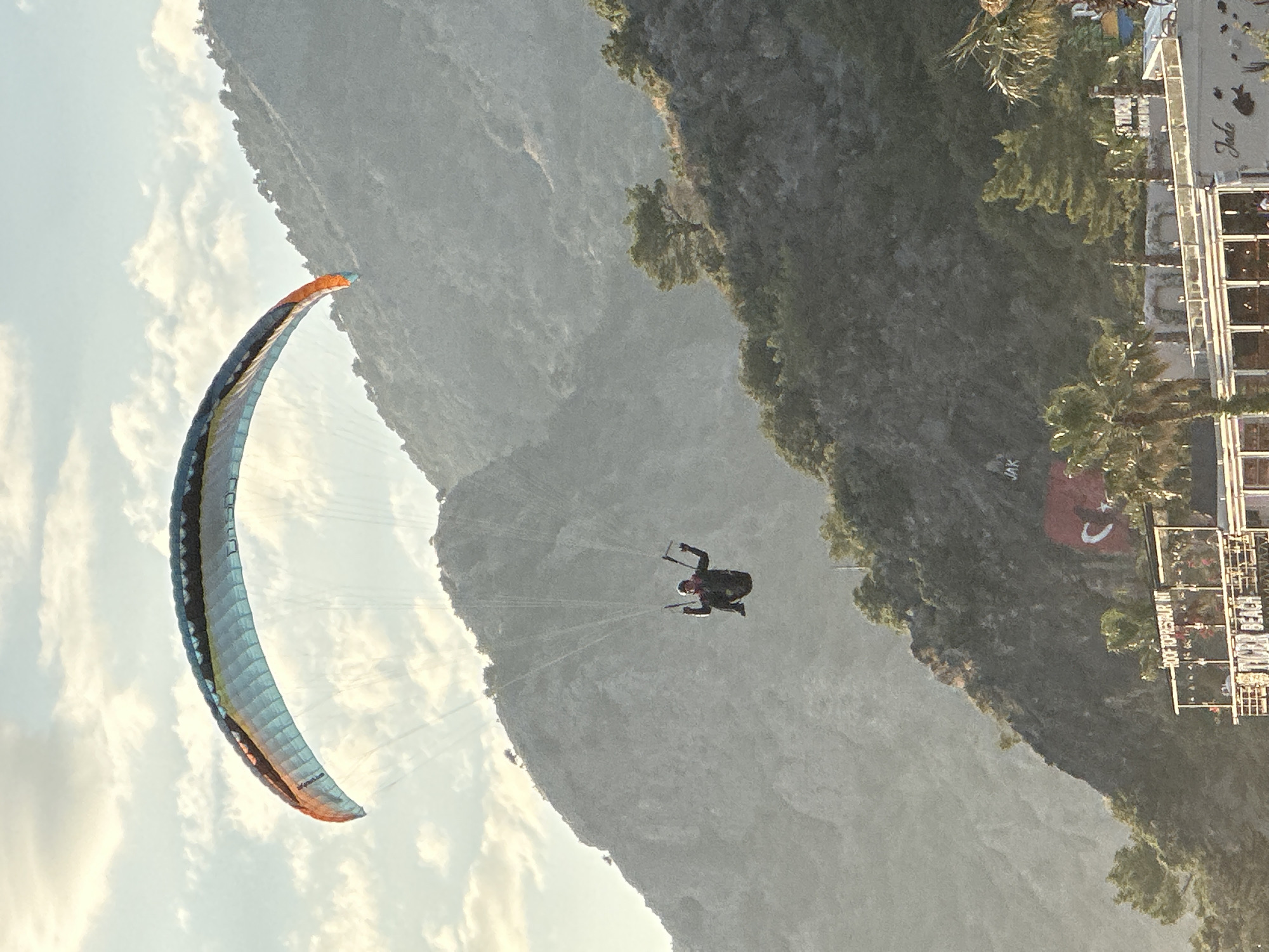 Paragliders active over crowded Fethiye boardwalks, Turkey