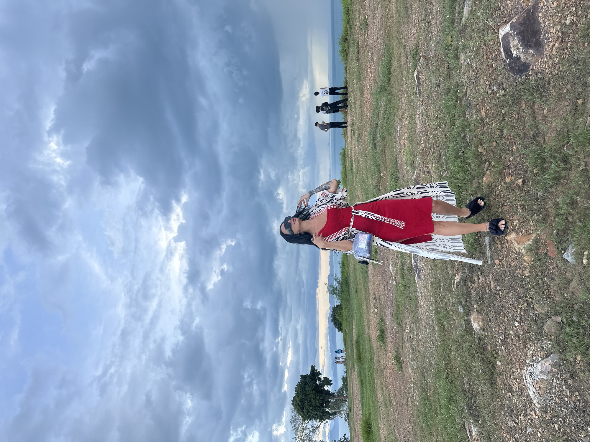 Tourists gather at Thai coastal viewpoint under dramatic skies