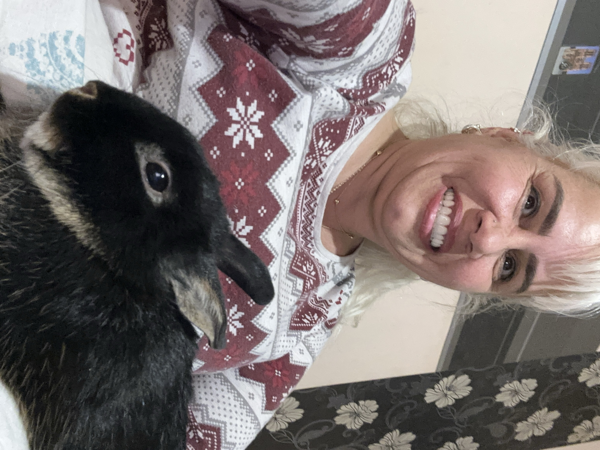 Woman poses with dark rabbit for selfie in Sofia