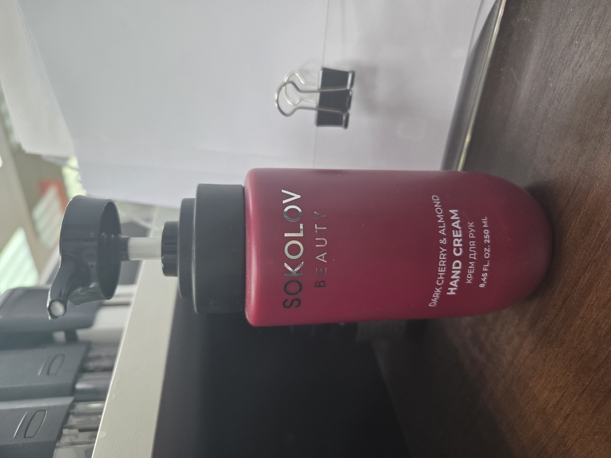 Hand cream bottle observed on wooden surface with product residue