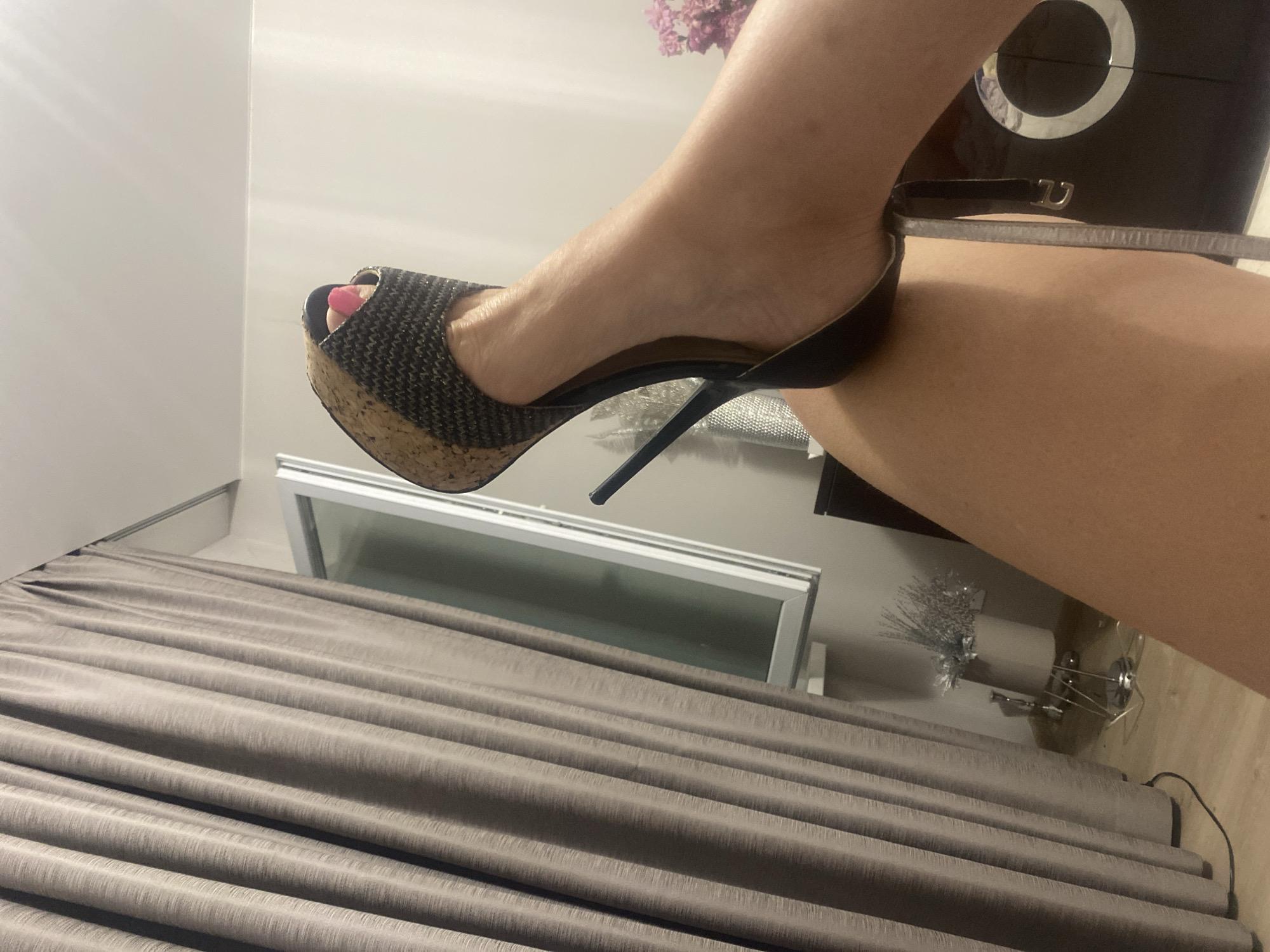 Getting ready at home: heels, a floral dress, and painted nails