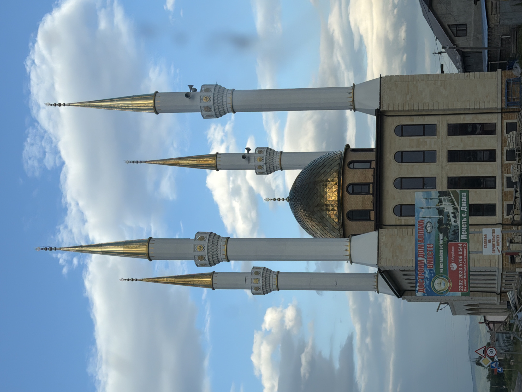 Golden-domed mosque with four minarets in Джага, Russia