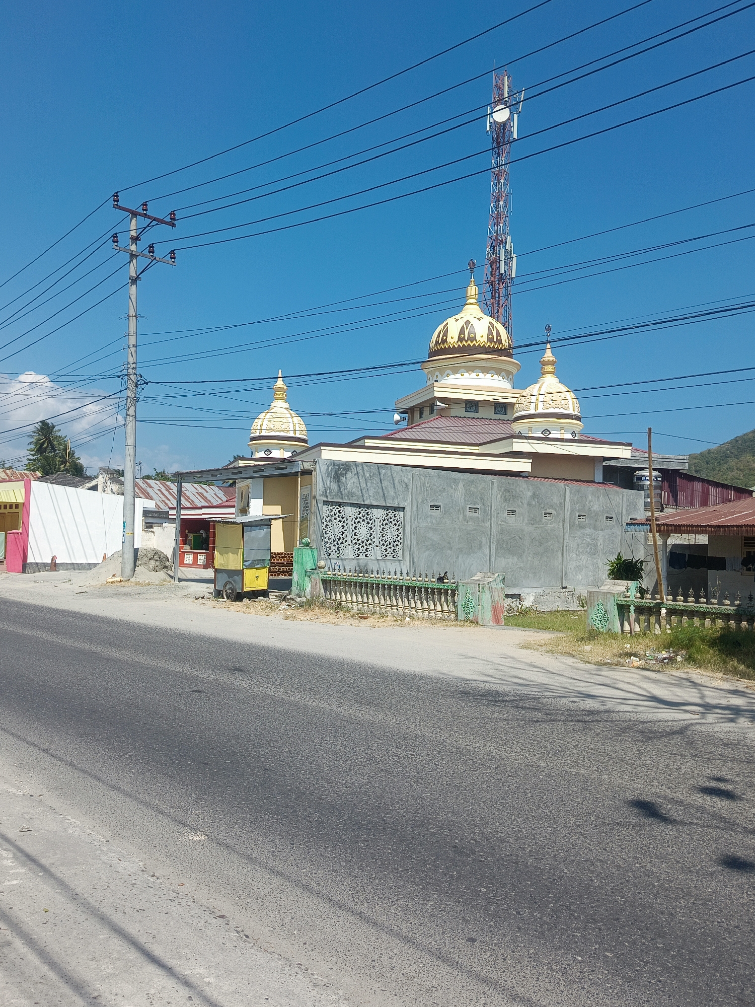 Golden-domed mosque along a road in Gorontalo, Indonesia