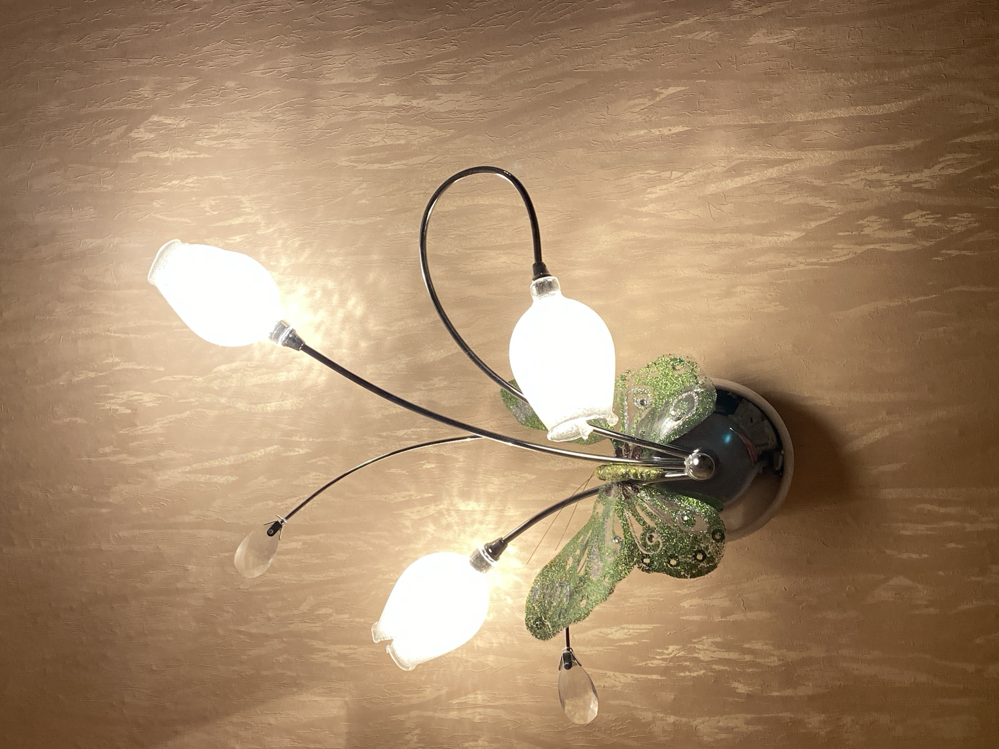 Interior details: butterfly lamp and gold-embroidered fabric