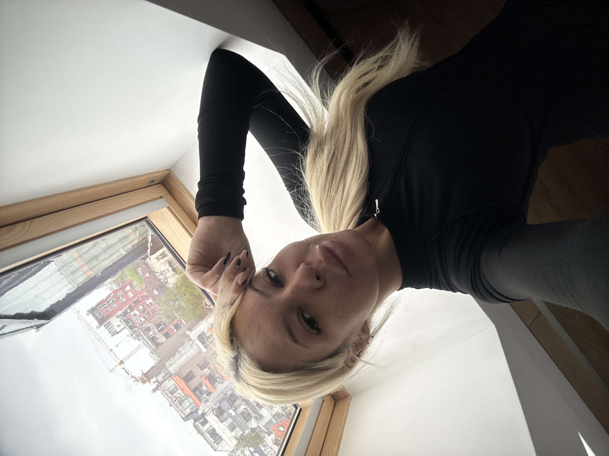 Woman takes mirror selfies in Sofia bedroom