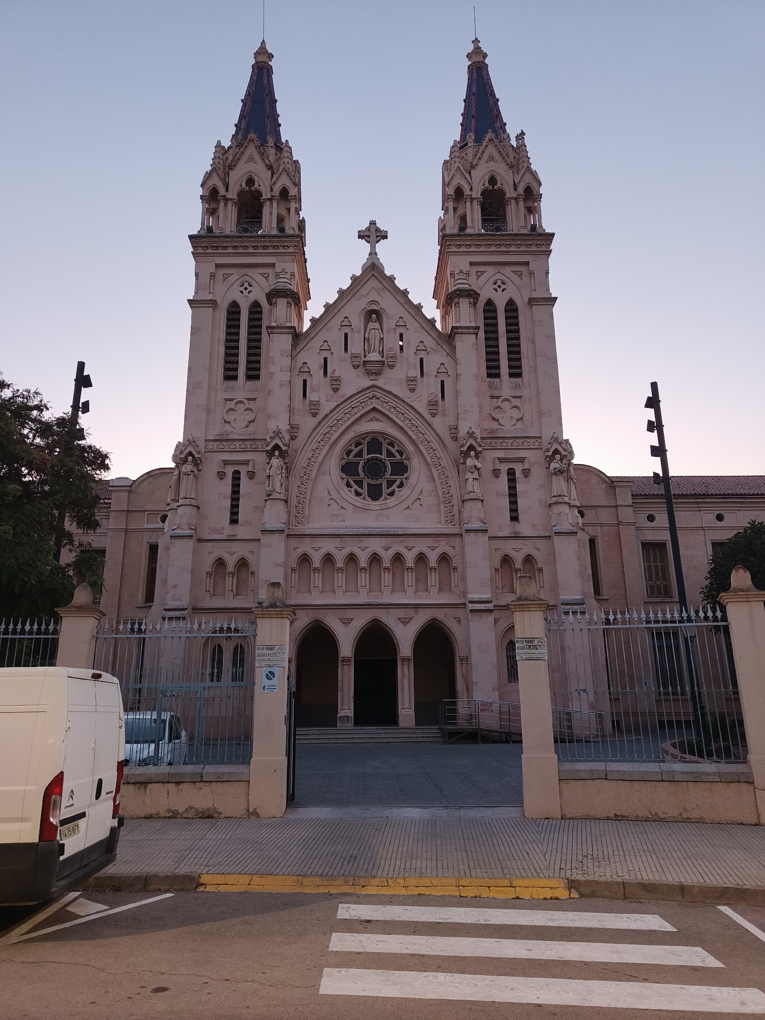 Ornate twin-towered church in Benirredrà at dusk