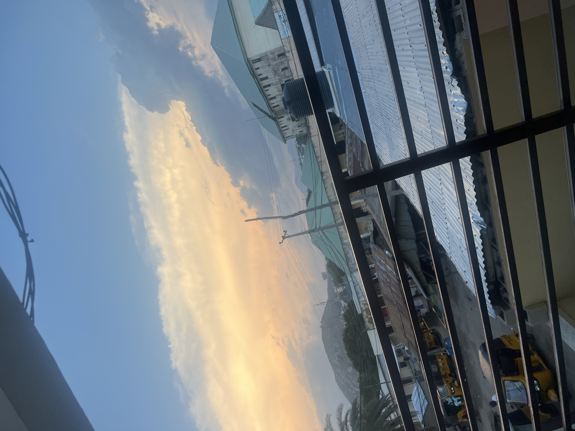 Jalingo at golden hour, streets and skyline under sunset clouds