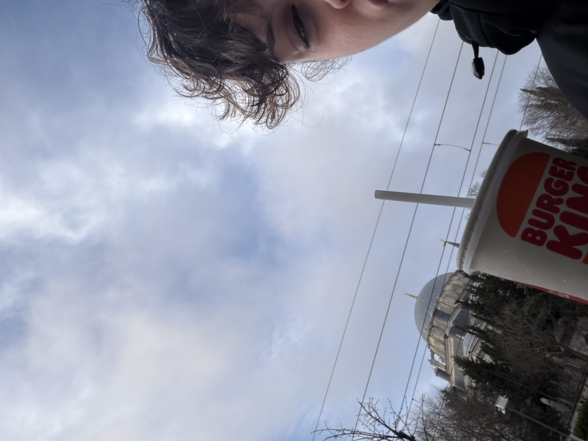 Person with fast food drink photographed near Istanbul mosque