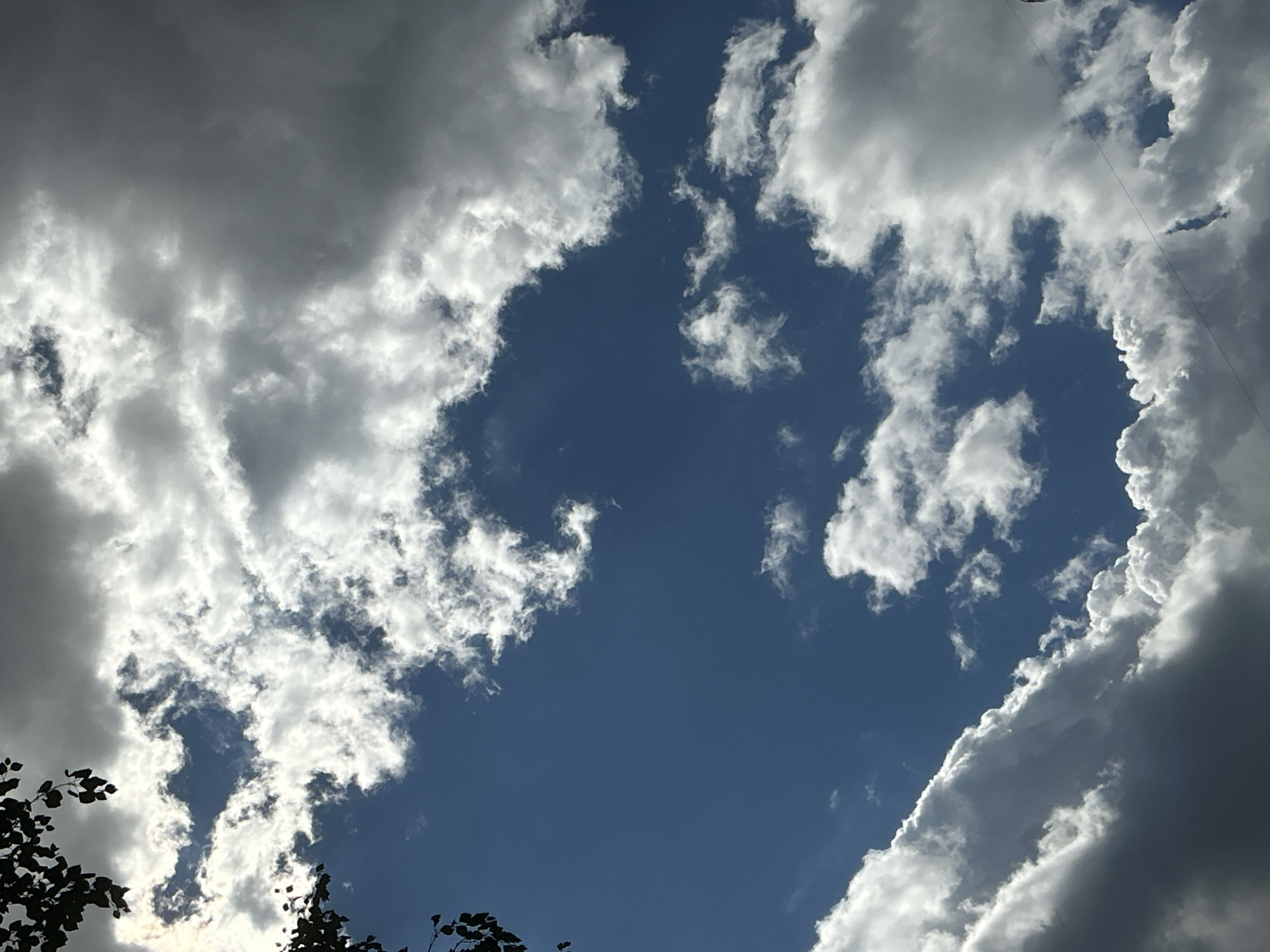 Looking up: dramatic skies and a curved skyscraper