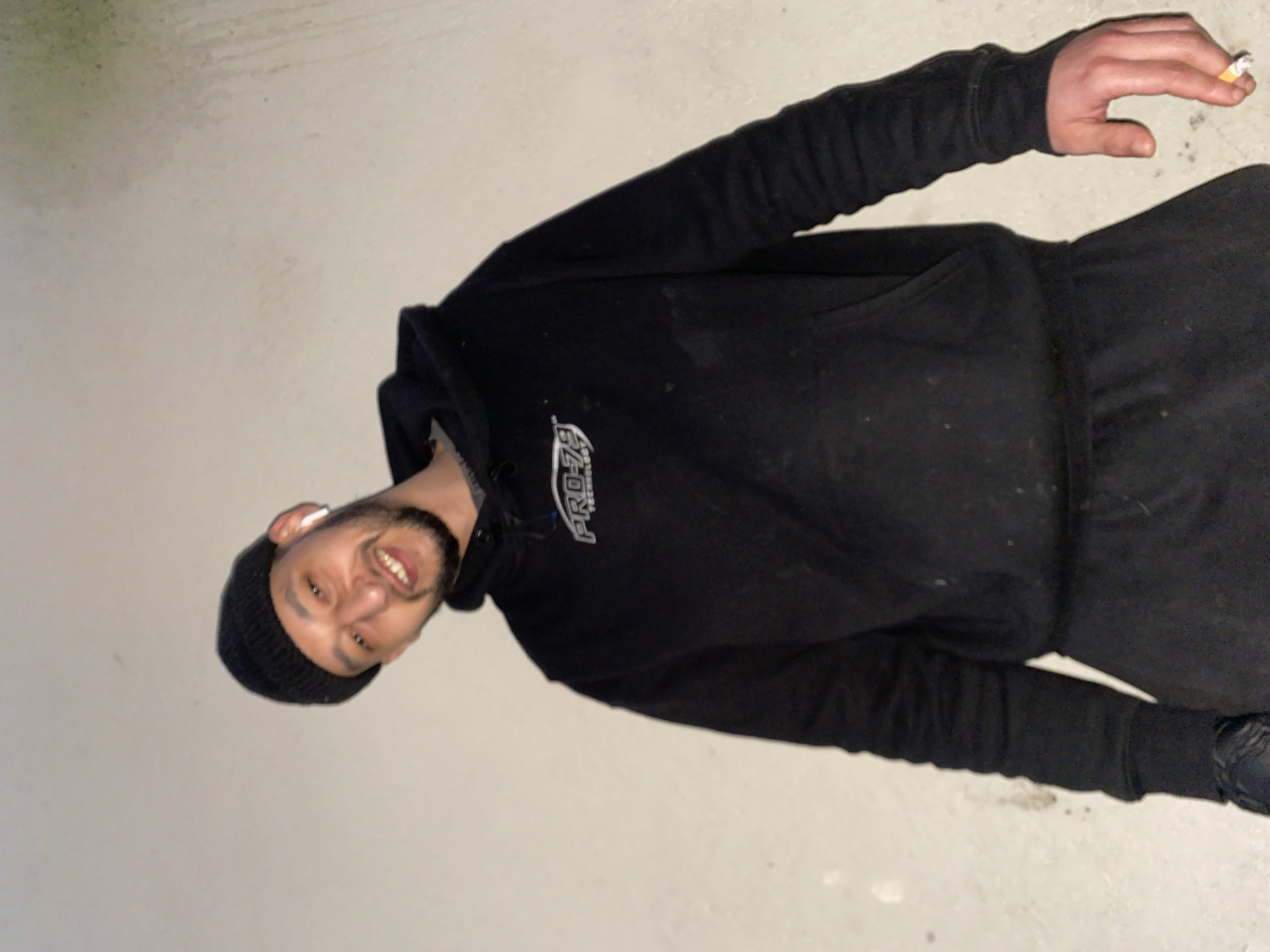 Man in black clothing smoking, relaxing in Schiltigheim