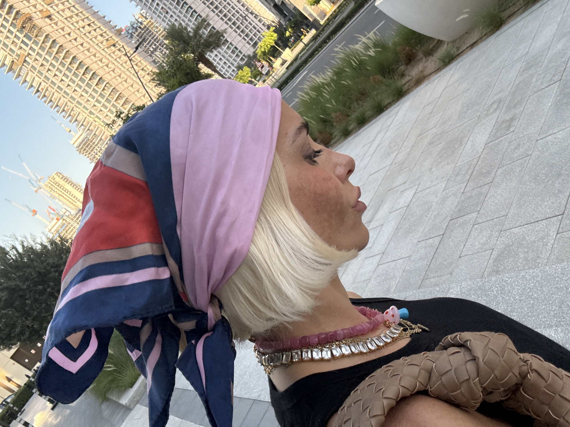 Woman in colorful headscarf photographed around Dubai