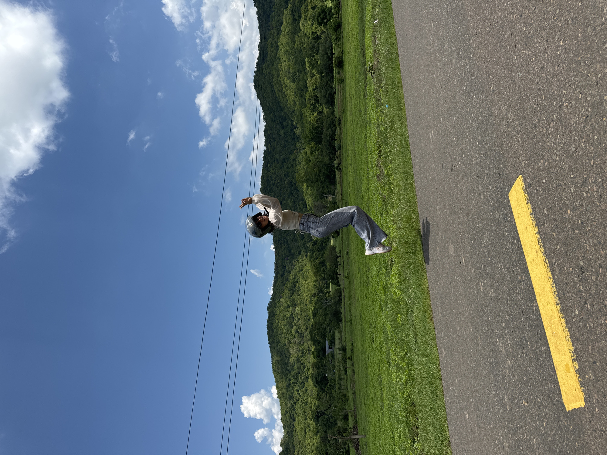 Woman poses and celebrates on scenic Vietnam road