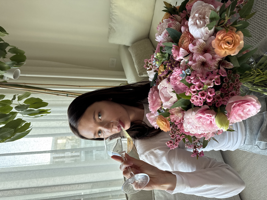 Woman enjoys afternoon terrace time with flowers in Eilat