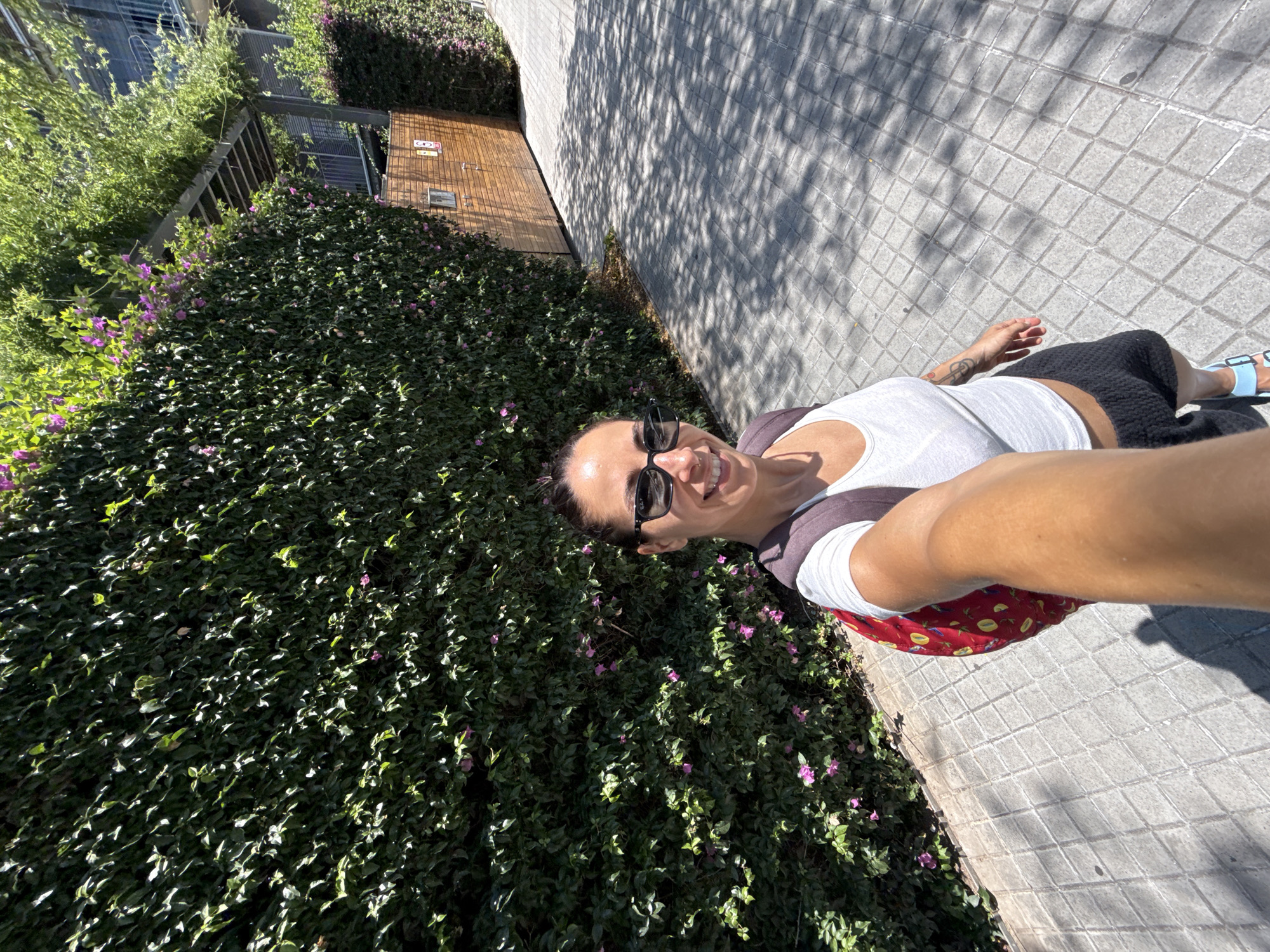 Noon stroll past Barcelona's glass towers and flowering walls.