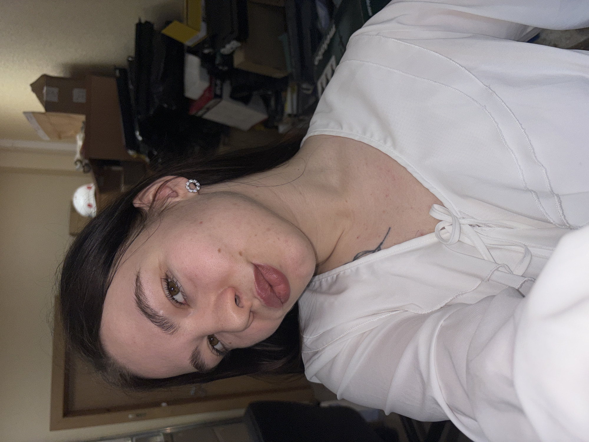 Woman in white blouse photographed indoors in Perm, Russia