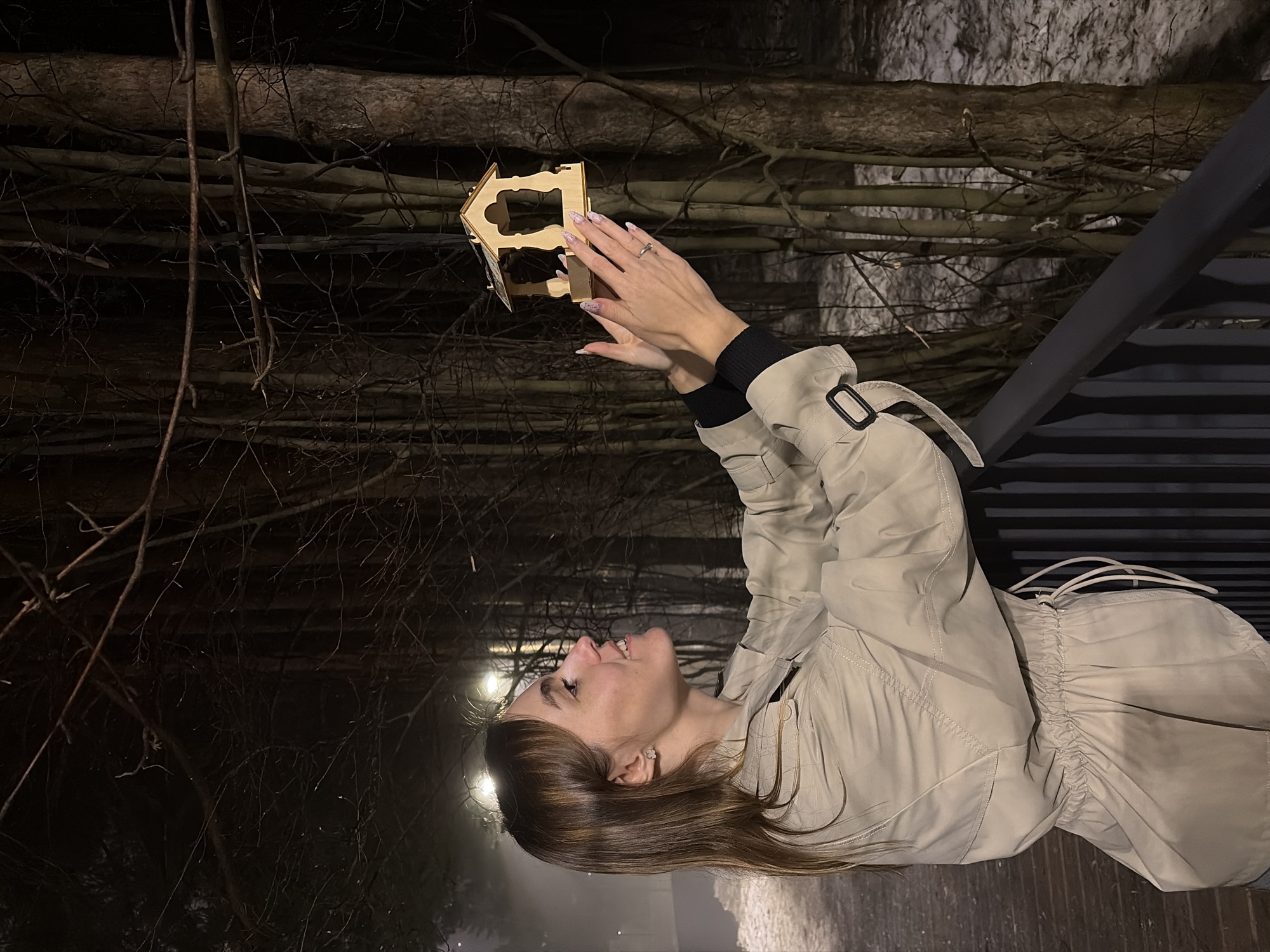 Woman poses on bridge during foggy evening in Izhevsk
