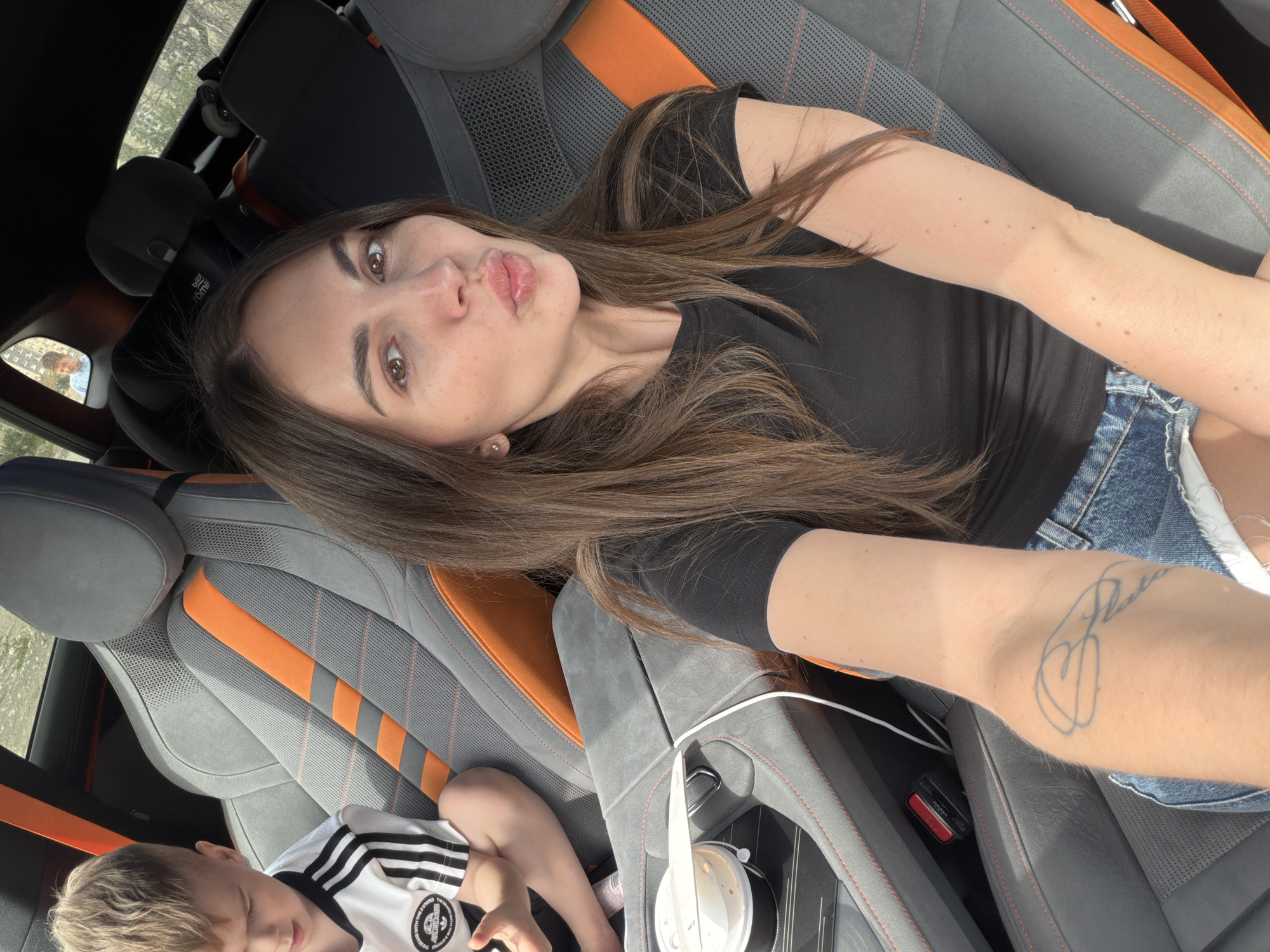 Adult takes selfie inside vehicle in Bishkek, Kyrgyzstan