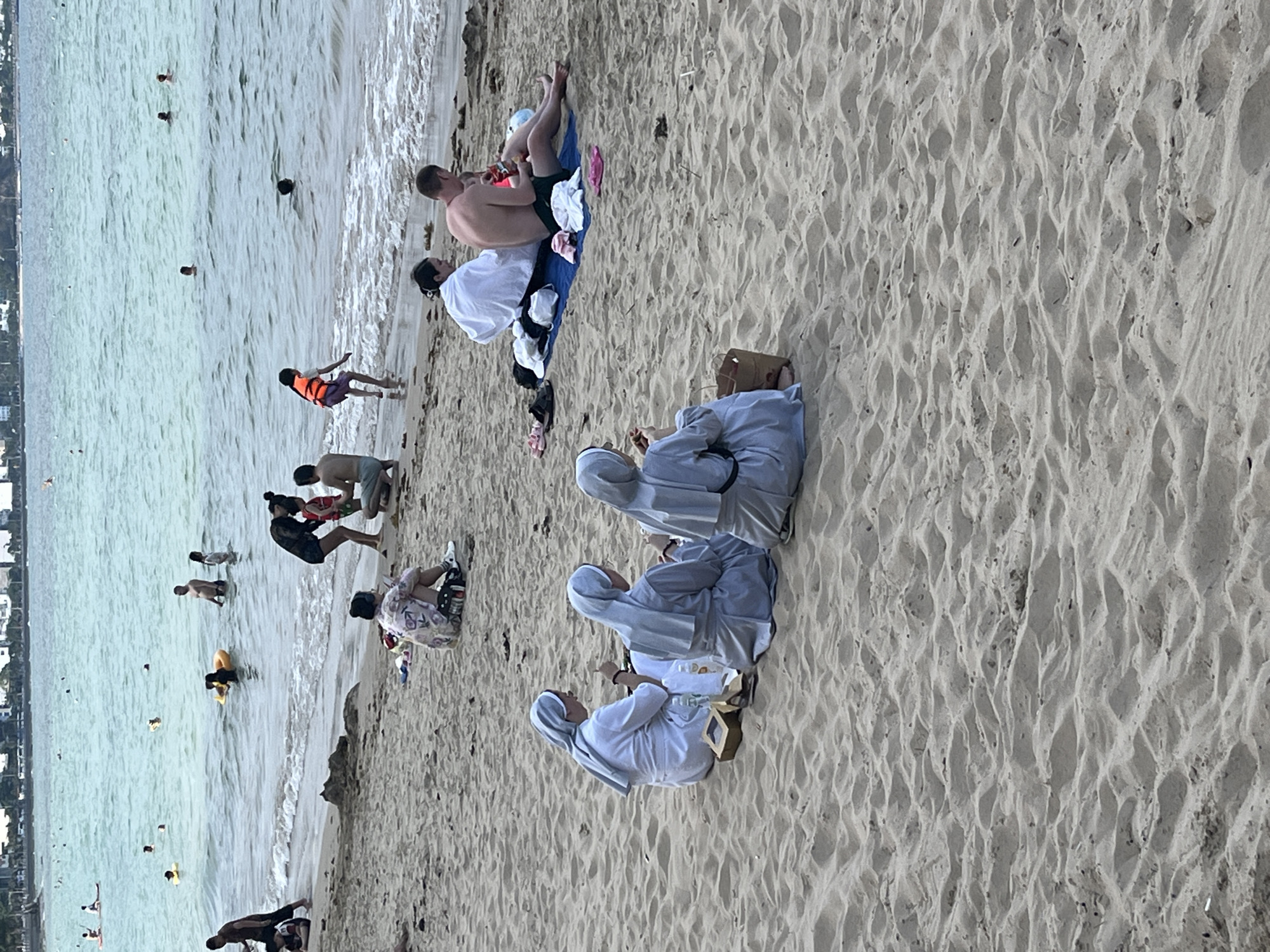 Beach gathering includes swimmers, couples, nuns in Bắc Nha Trang