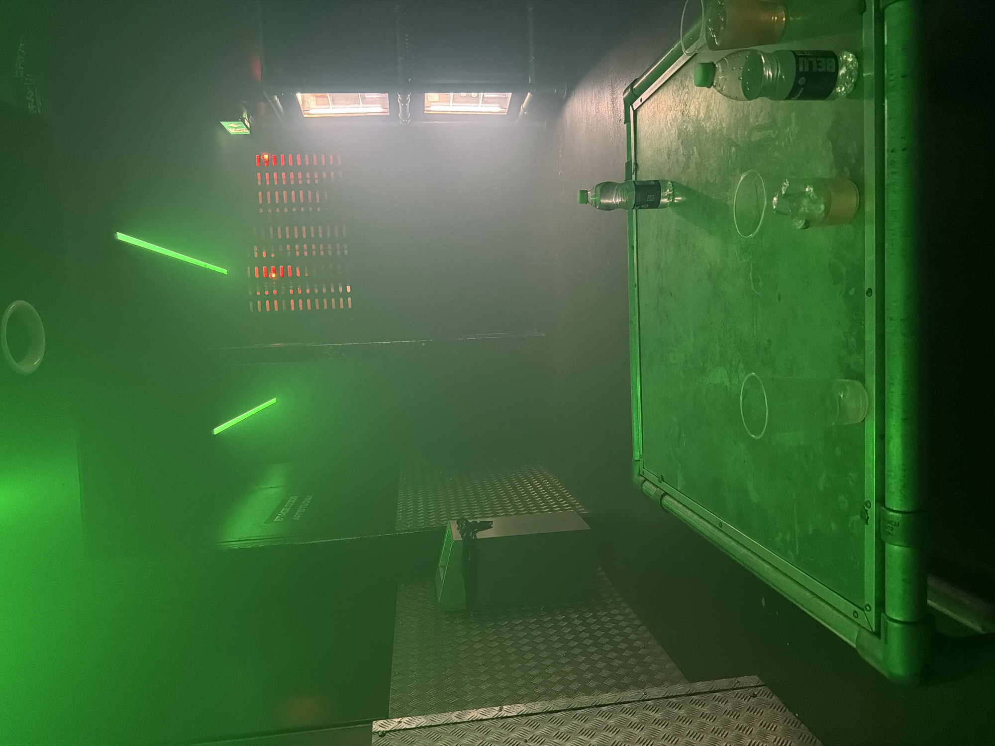 Green-lit backstage area captured at London performance venue