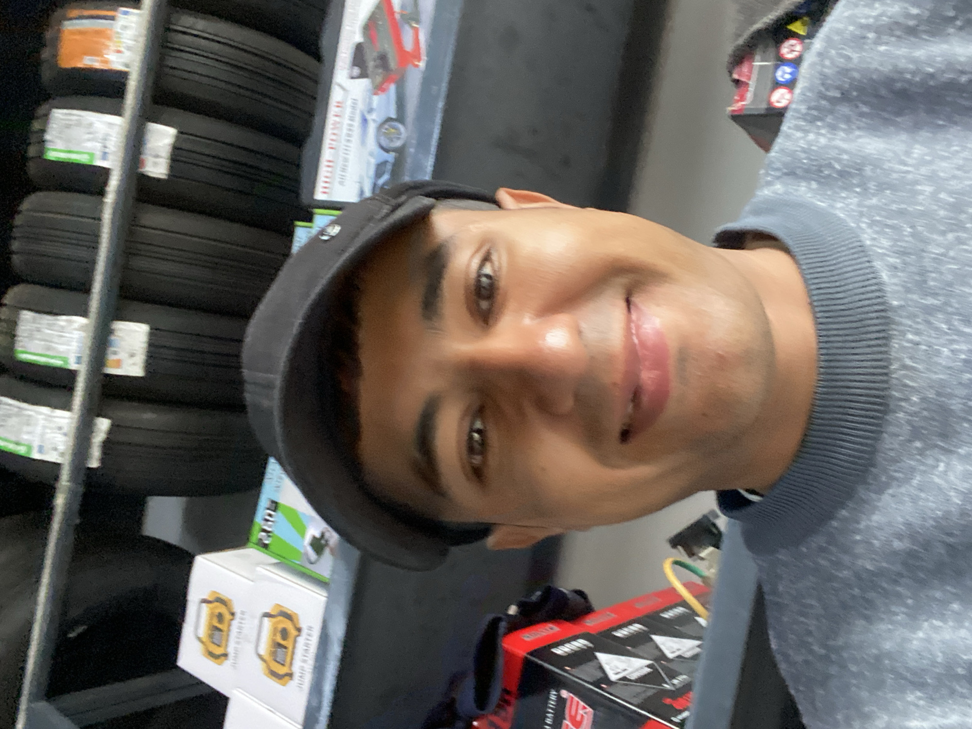 Man takes selfies in automotive store in Bukhara