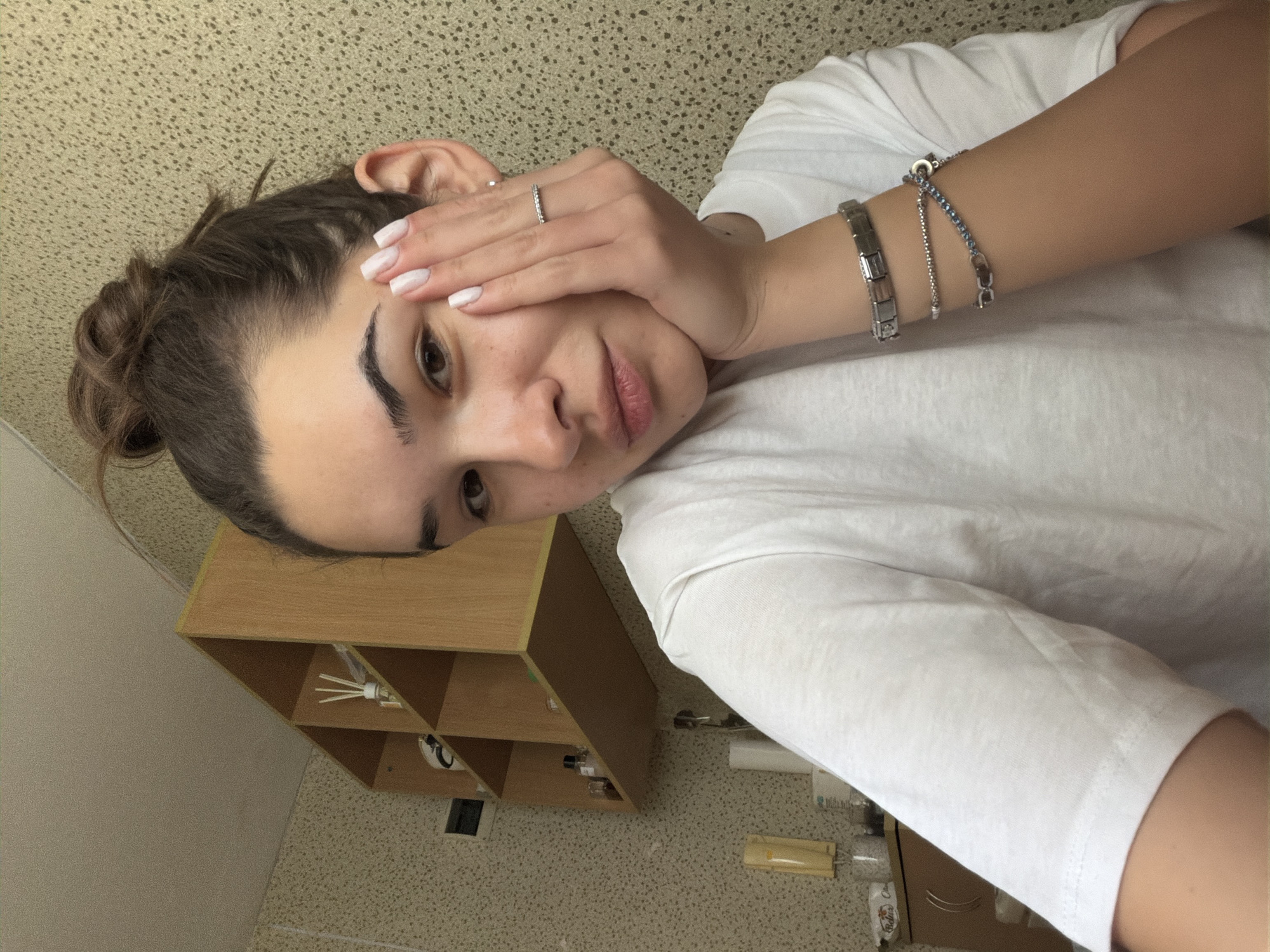 Woman takes indoor selfie in Sofia wearing white shirt