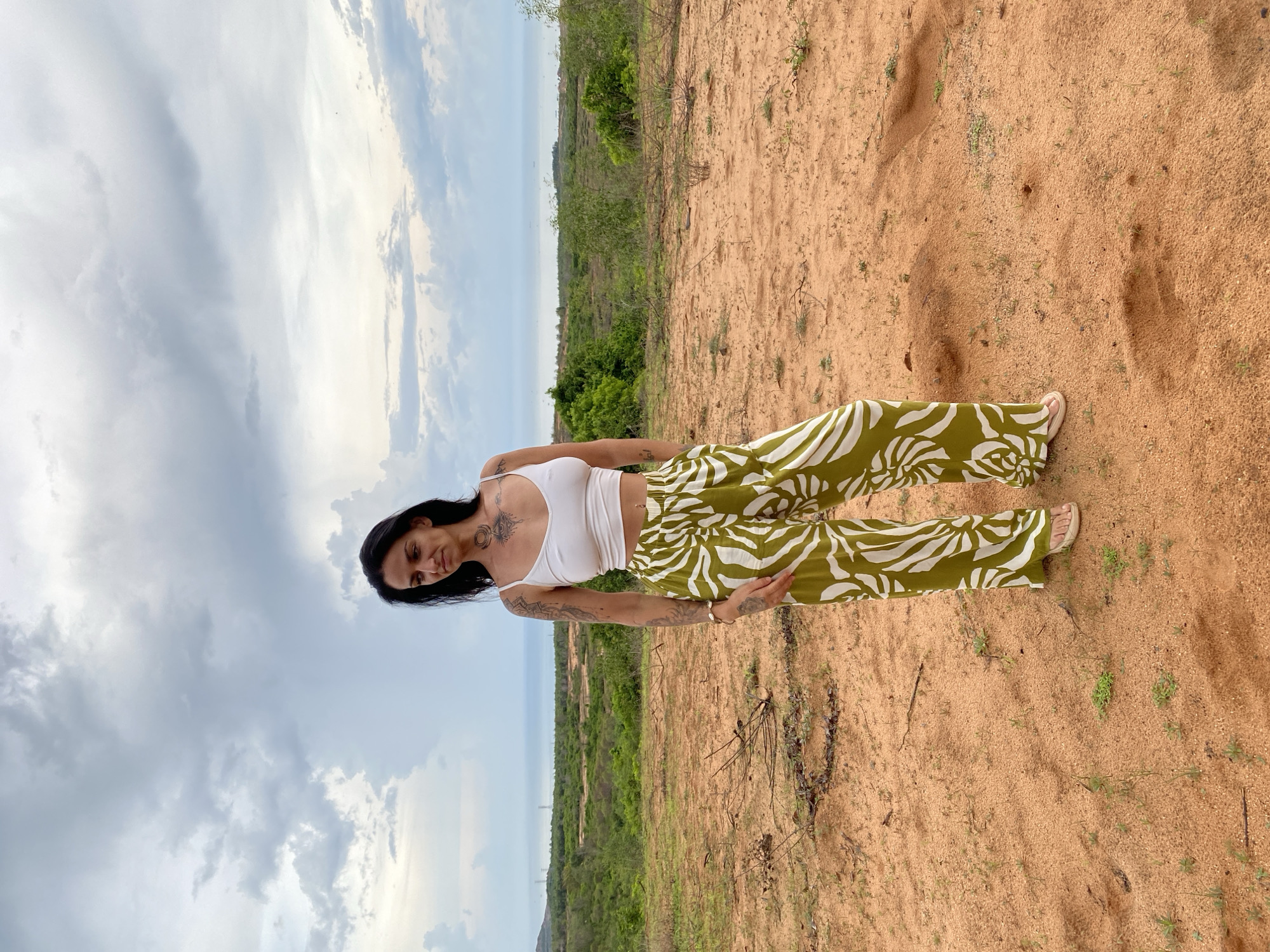 Two women photograph wind turbine visit in Mui Ne, Vietnam