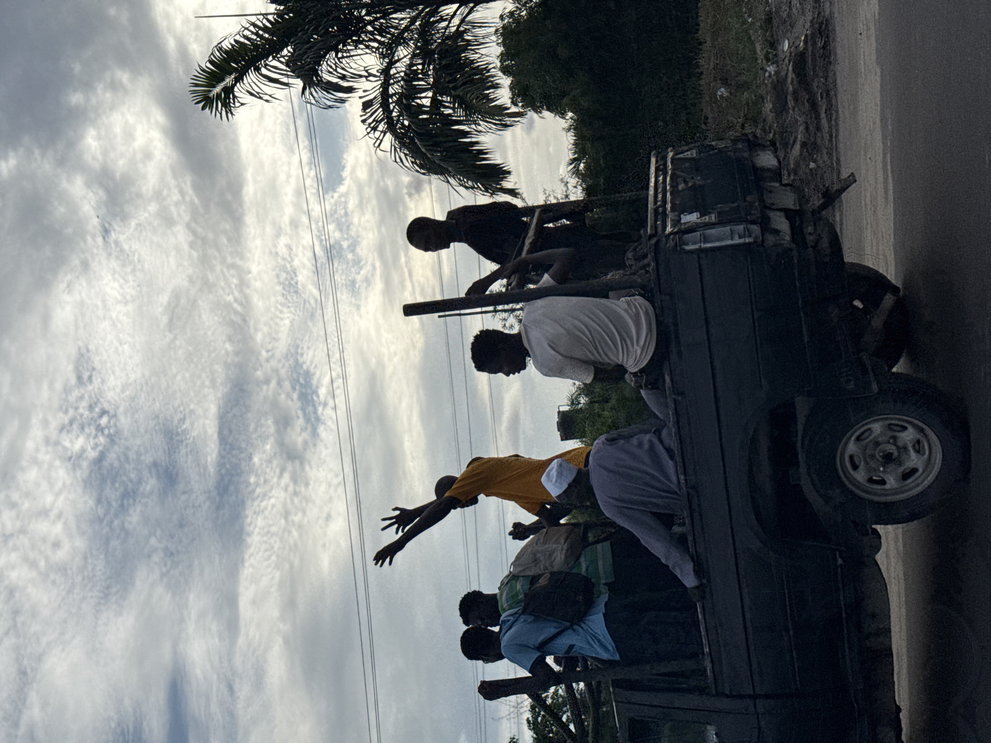 People ride in pickup truck bed in Lekki, Nigeria