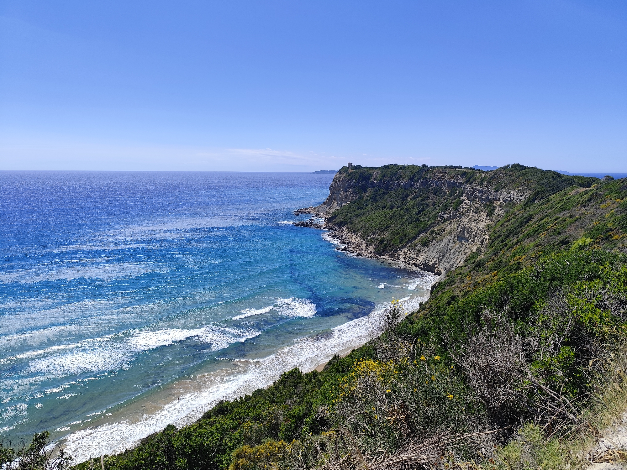 Clear skies frame Agios Stefanos coastal vista