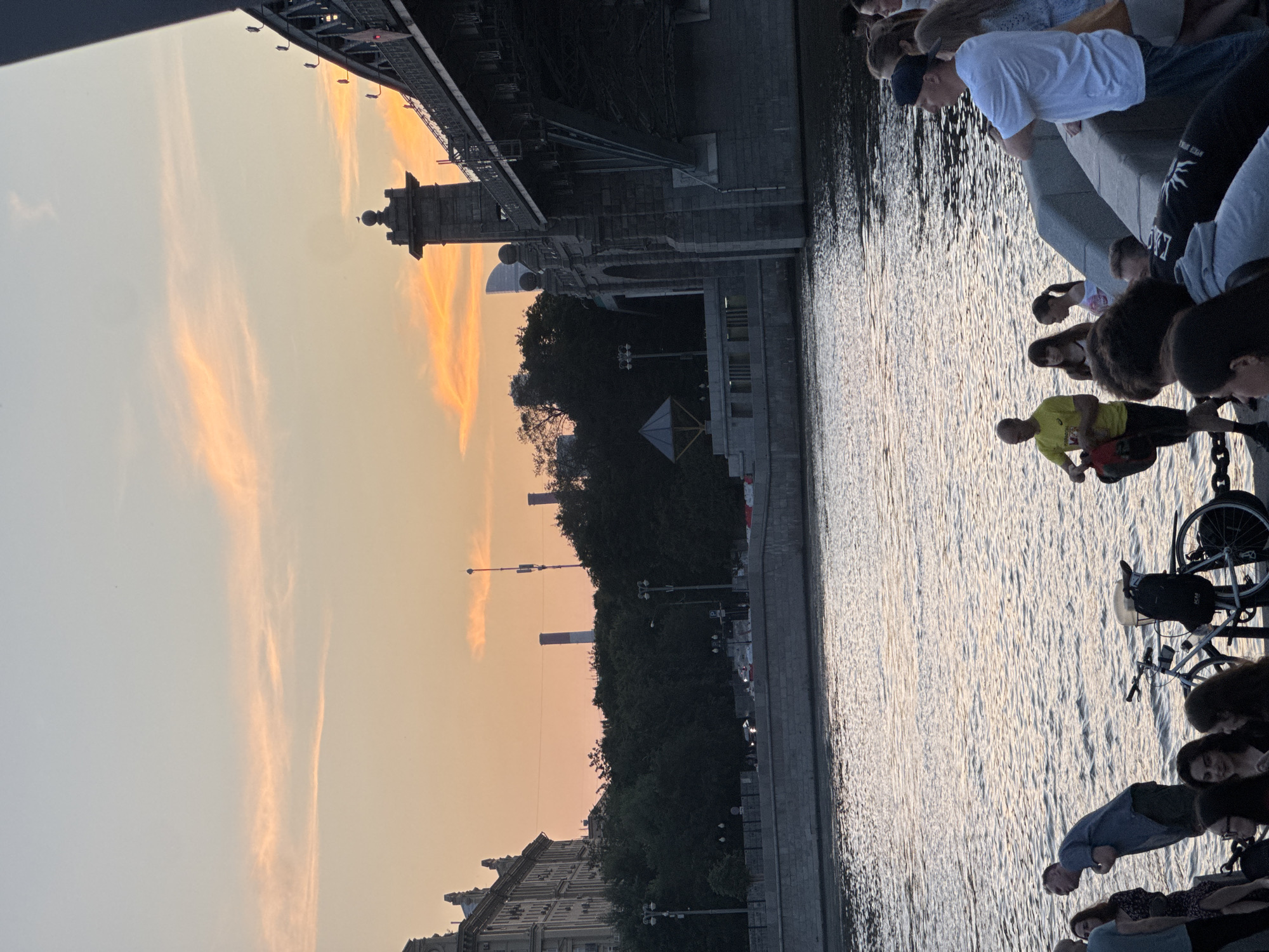 Social dancing on a Moscow riverfront deck at summer sunset