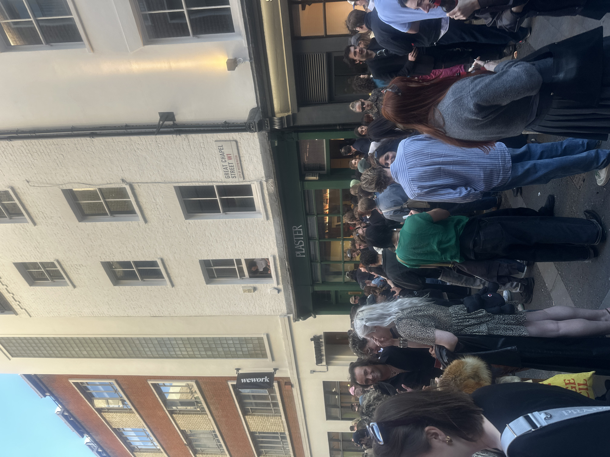Crowds gather for evening drinks on London's Great Chapel Street