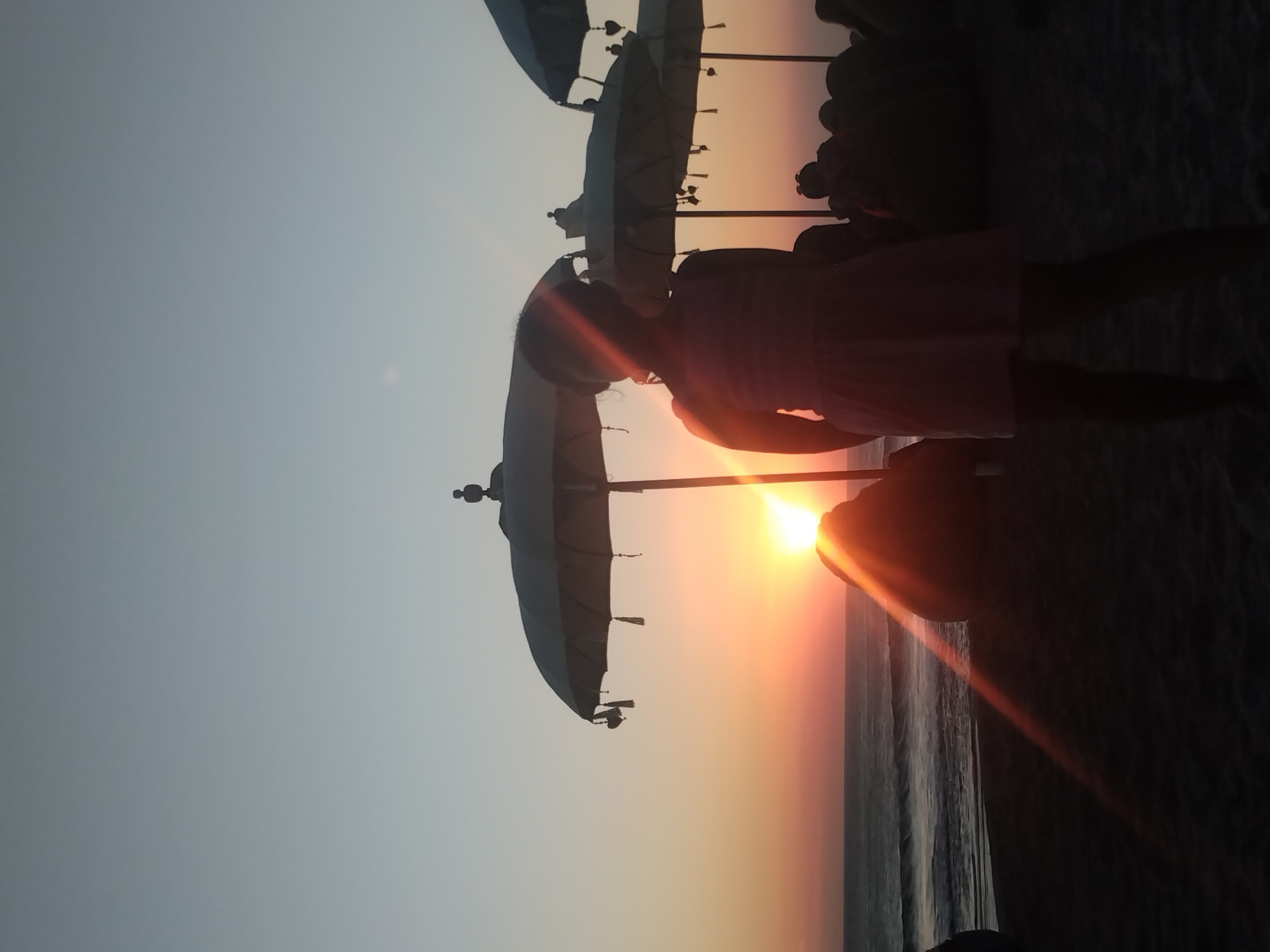 Family sunset gathering documented on North Kuta beach Indonesia