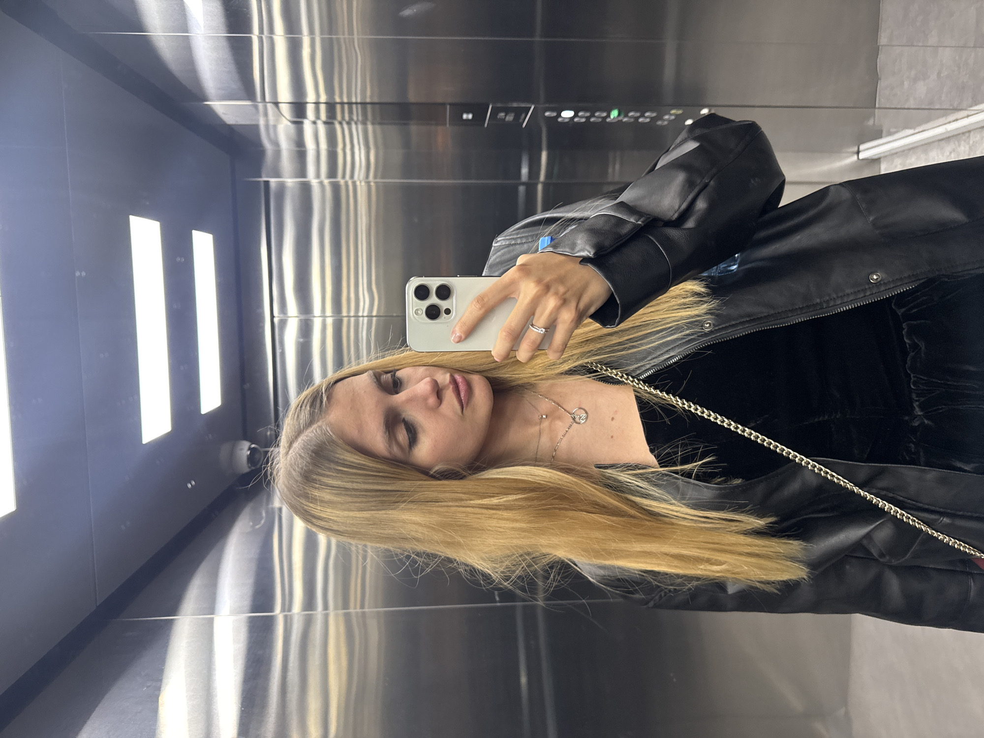 Woman Takes Selfie in Elevator While Wearing Black Leather