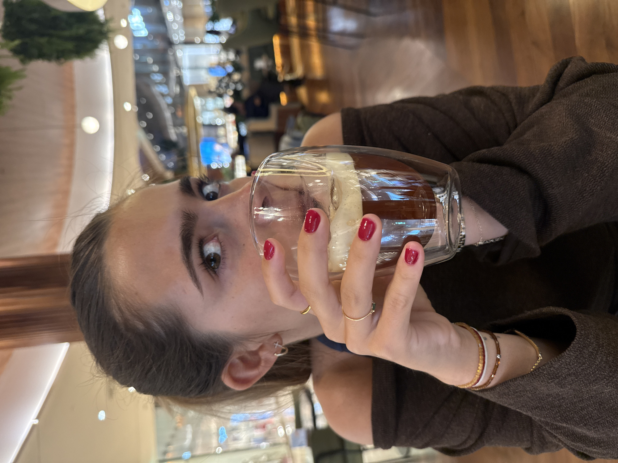 Woman enjoys layered drink at Matosinhos café