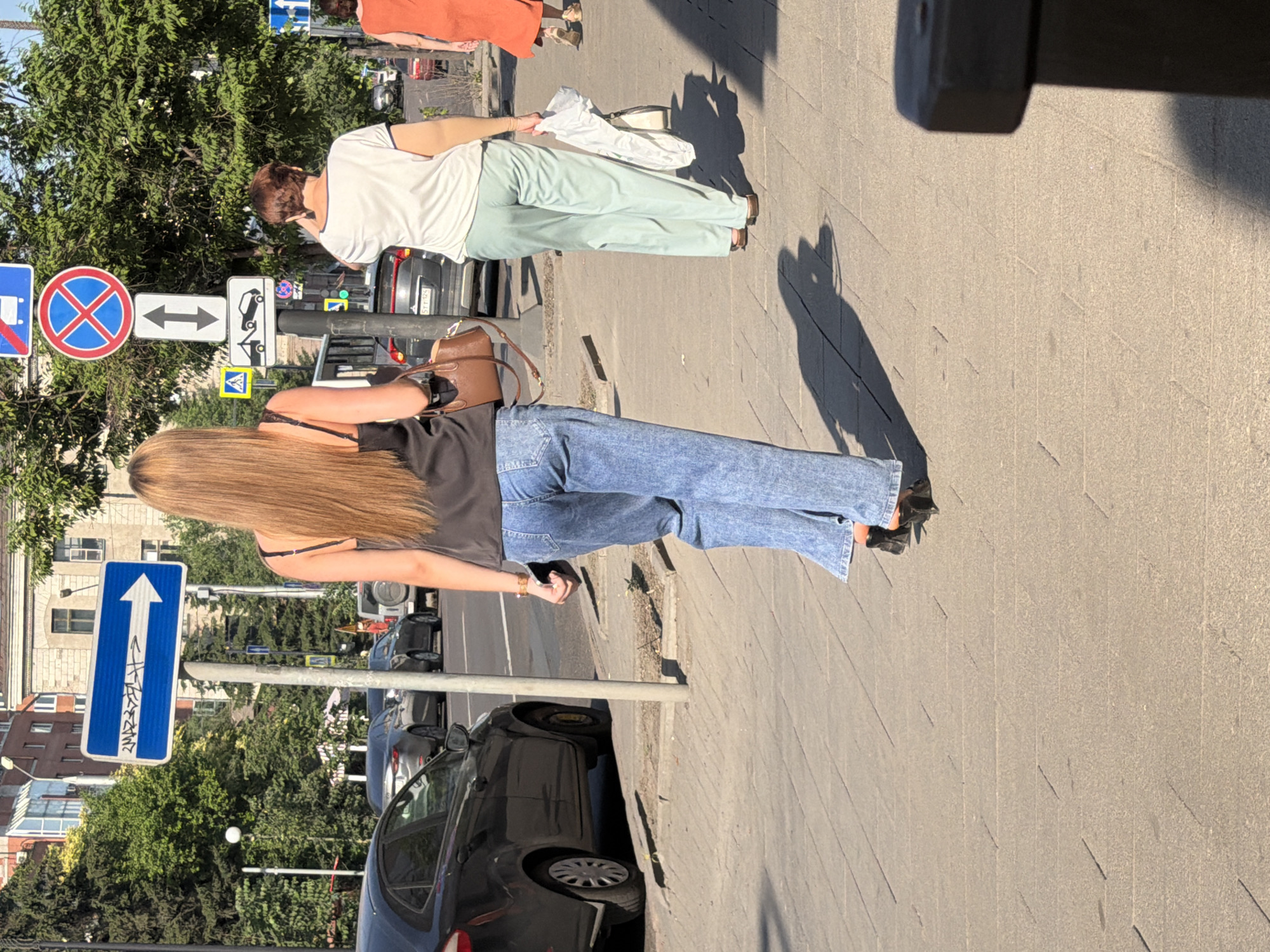 Summer street life along a Krasnoyarsk sidewalk