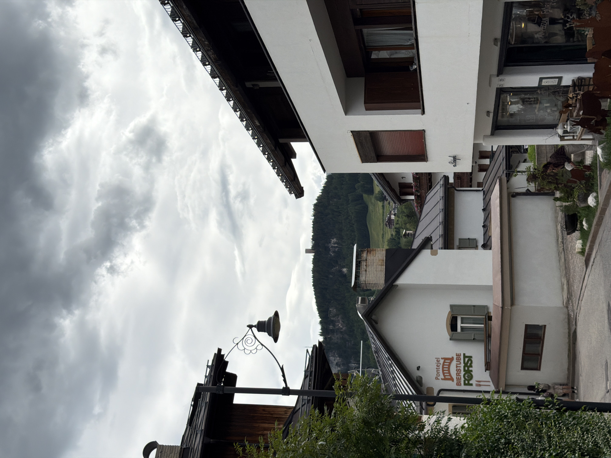 Afternoon in an Alpine town — streets, scaffolding, and mountain views
