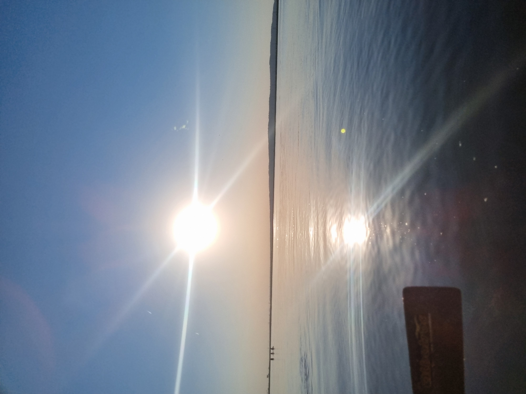 Sunny afternoon captured over water in Chaikovsky, Russia