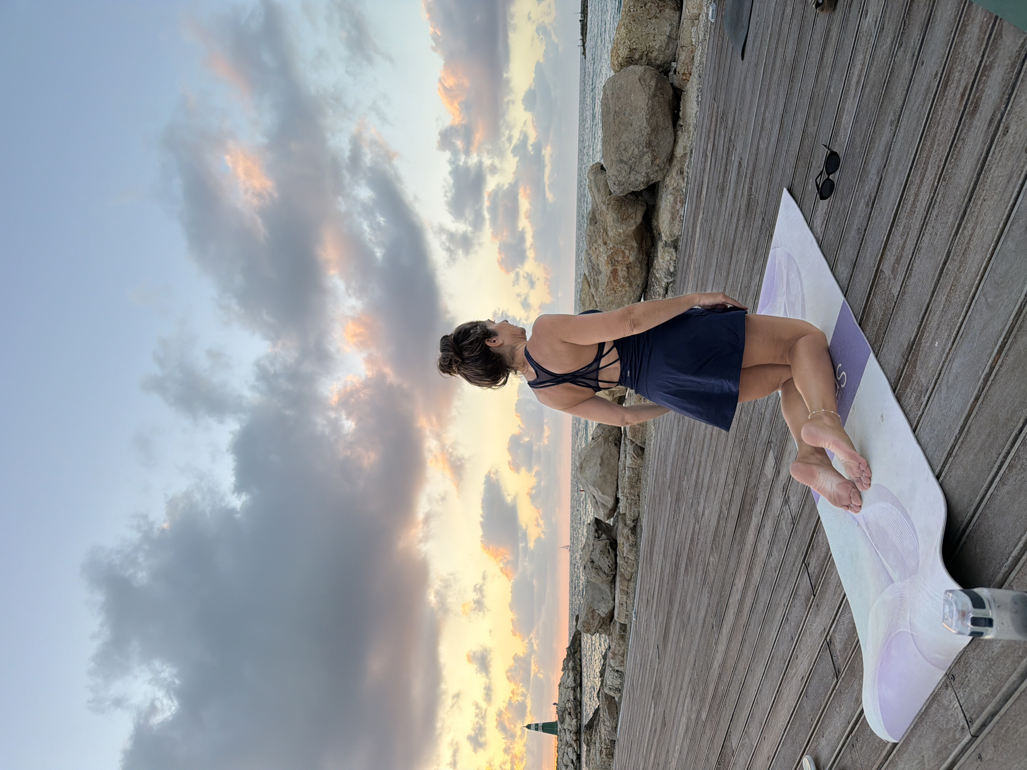 Yoga session on seaside wooden deck in Tel Aviv