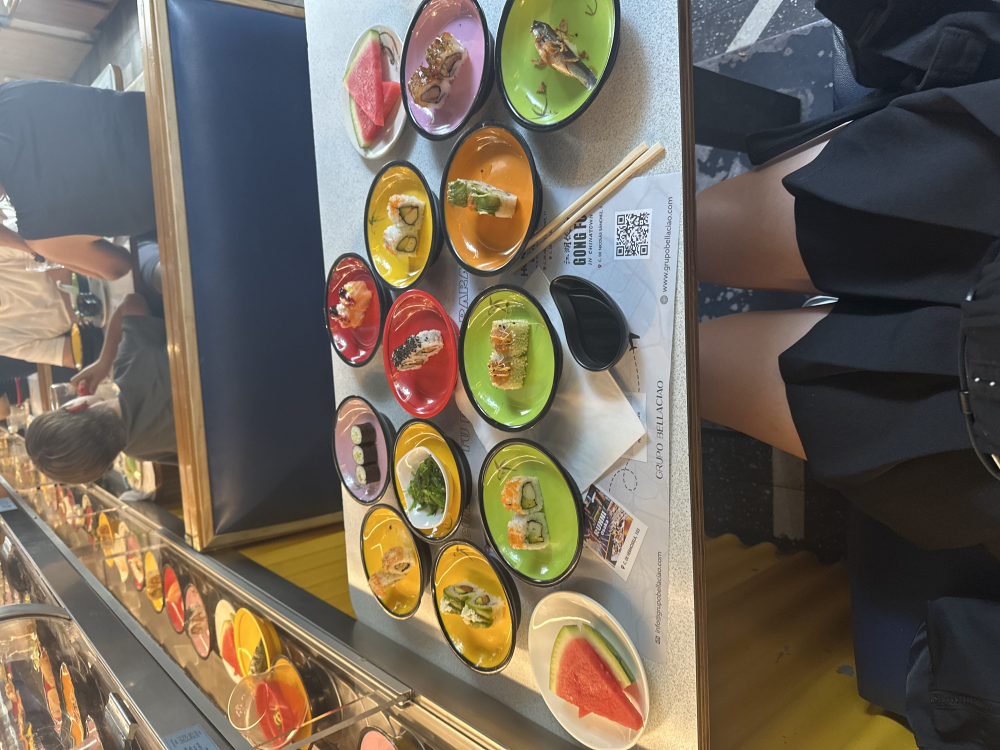 Diners enjoy conveyor belt sushi restaurant in Madrid