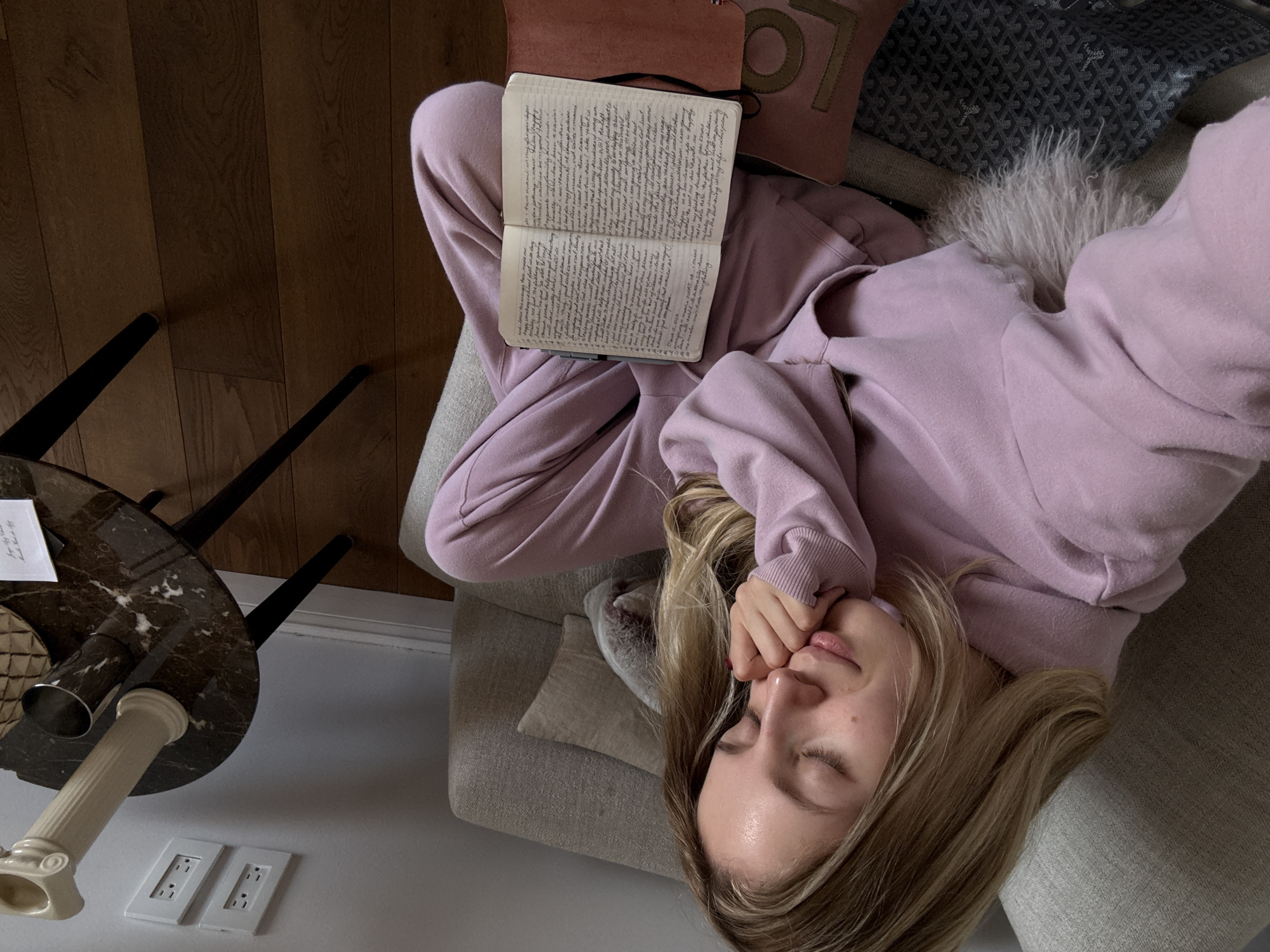 Woman rests on couch with notebook in Mexico City