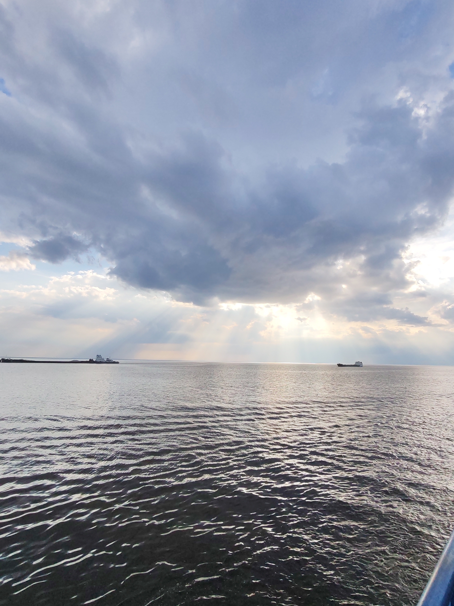 Cargo ship transits Russian waters under dramatic cloudy skies