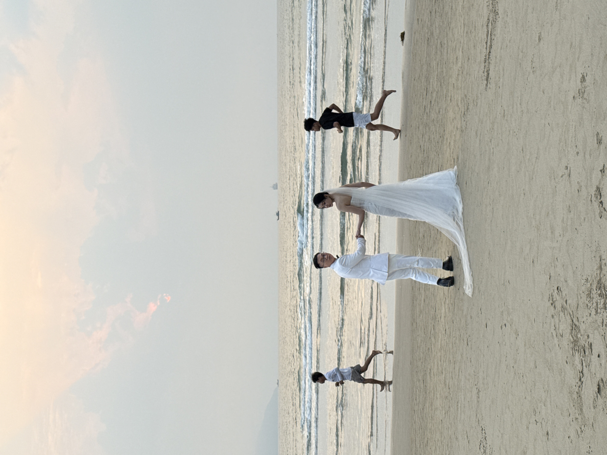 Wedding couple poses for beach photos in Đà Nẵng