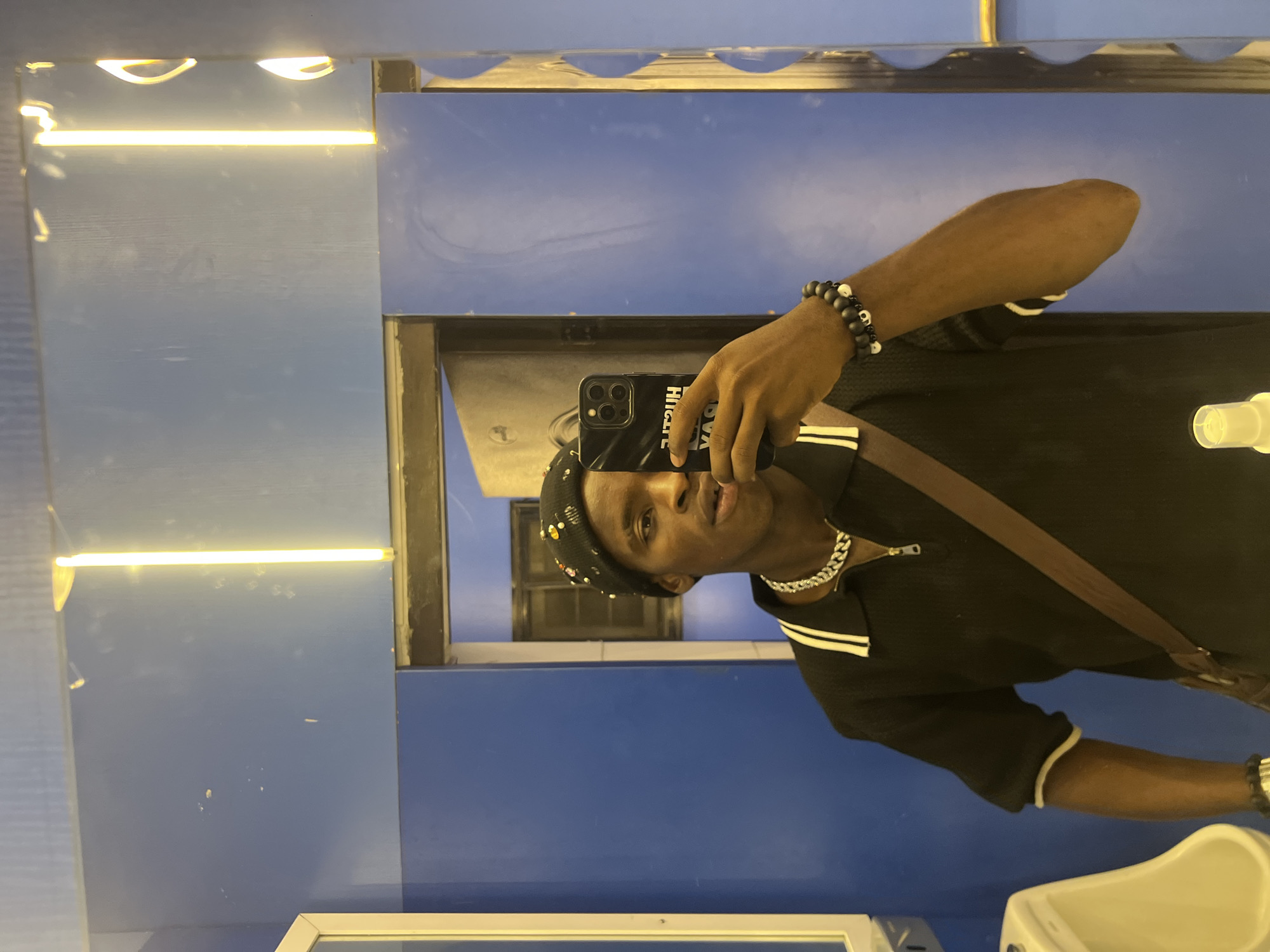 Person Takes Multiple Selfies at Nigeria Venue During Evening