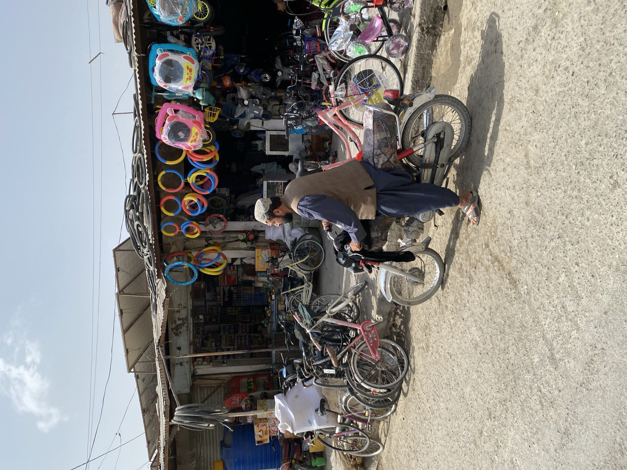 Street life outside a Kandahar bicycle shop, captured in motion