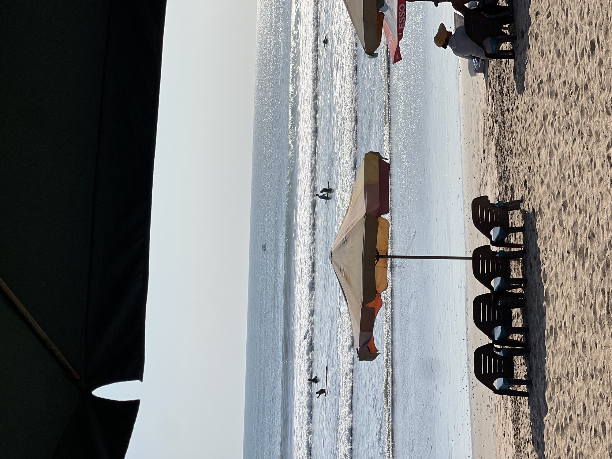 Busy morning at Kuta Beach — surfers, sand, and street life