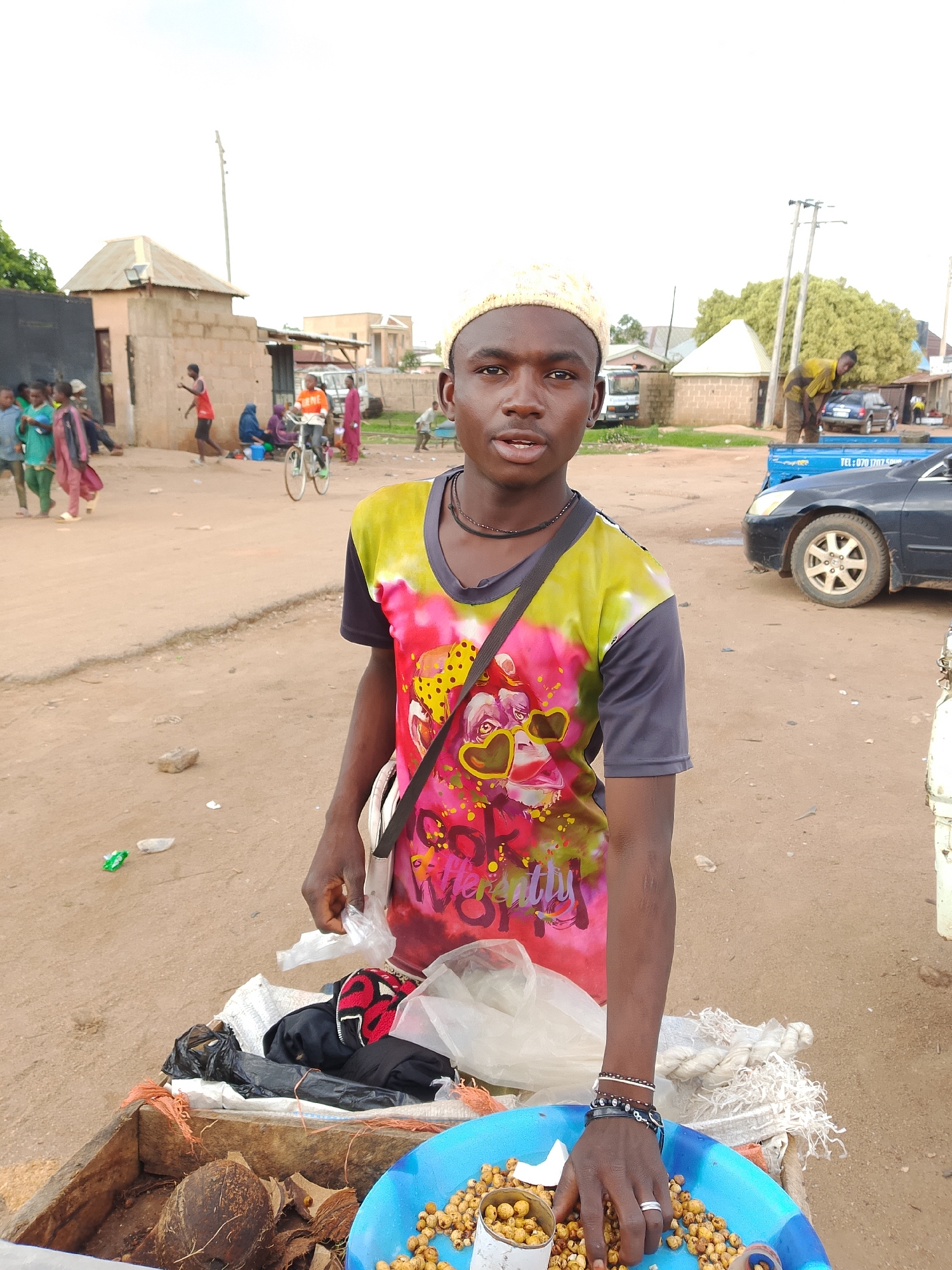 Everyday street life in a Bukuru neighborhood marketplace and yard